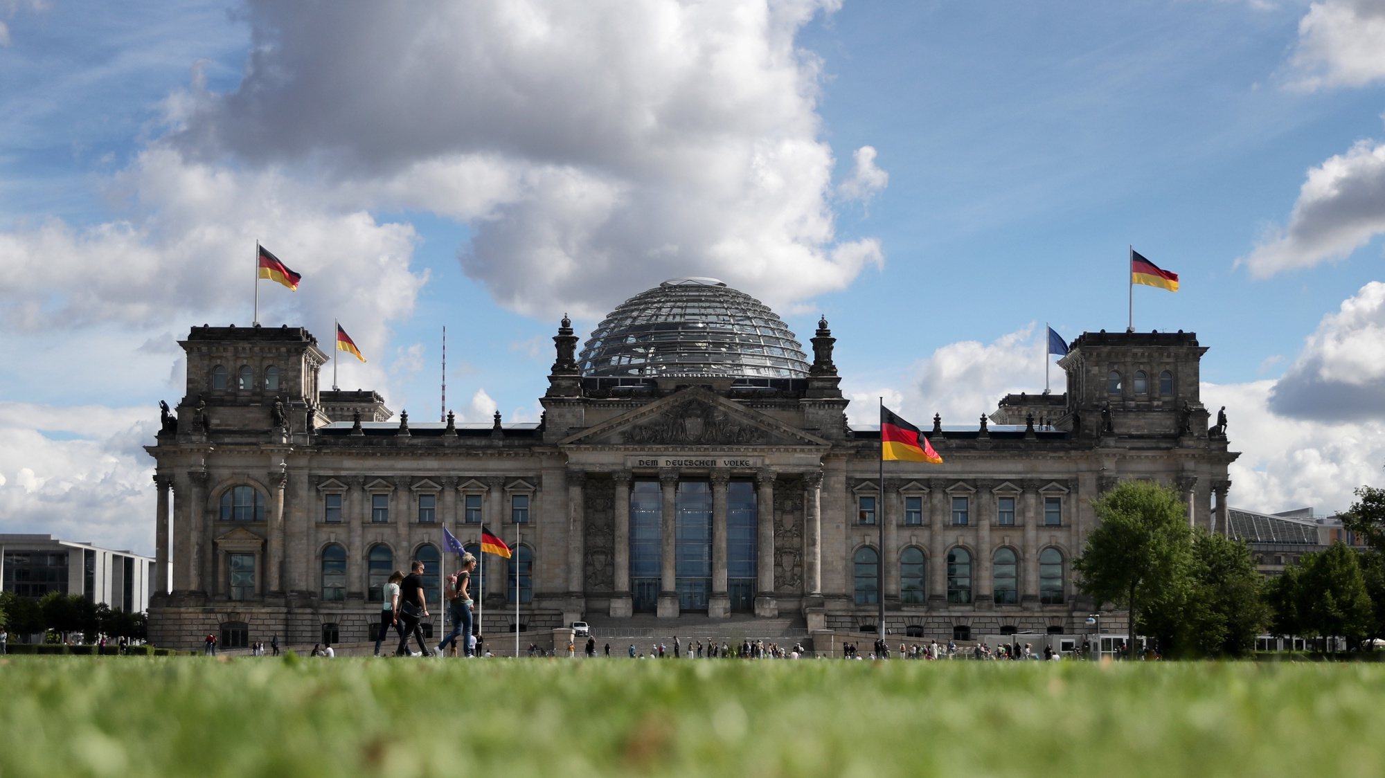 epa09477877 (FILE) - People walk in front of the German parliament Bundestag building in Berlin, Germany, 31 August 2020 (re-issued 20 September 2021). Germany will hold general elections on 26 September 2021.  EPA/HAYOUNG JEON