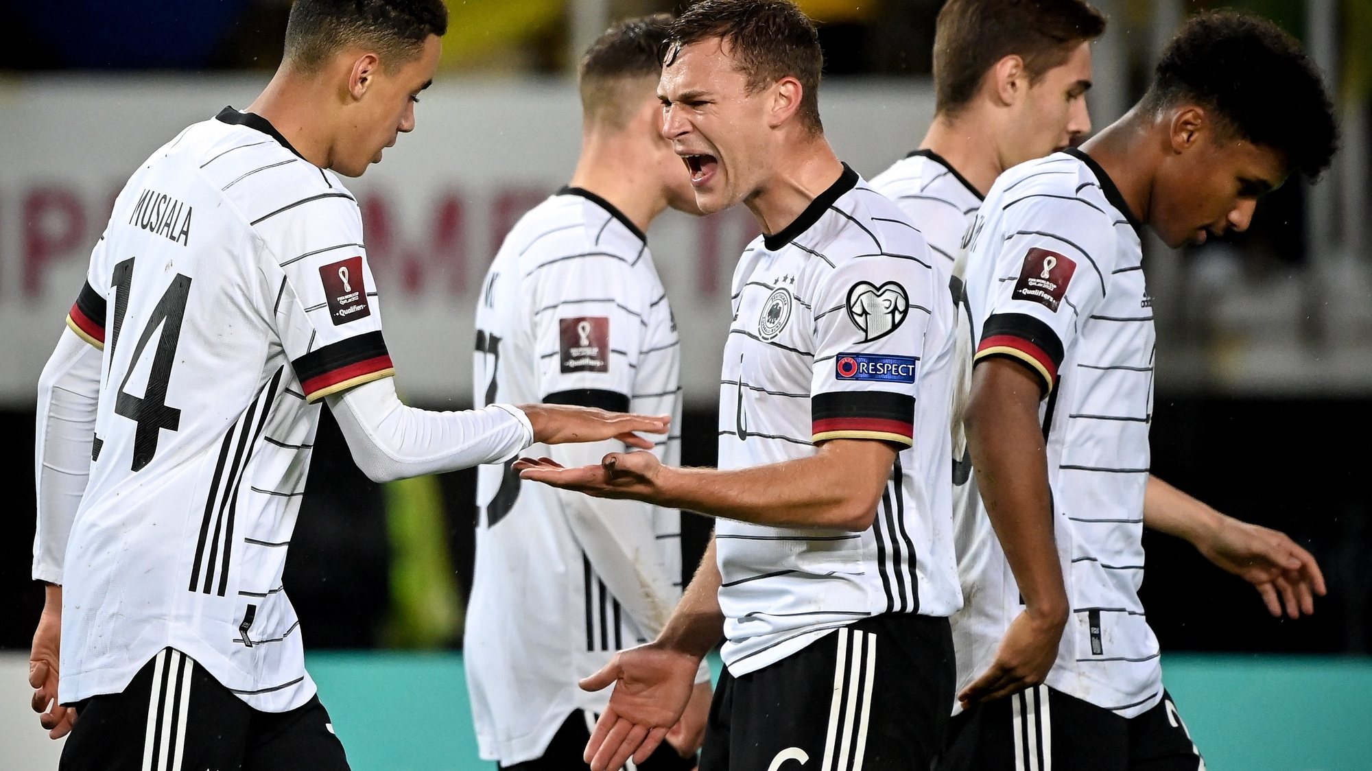 epa09519247 Germany&#039;s Jamal Musiala (L) celebrates with his teammate Joshua Kimmich (C) after scoring the 4-0 lead during the FIFA World Cup Qatar 2022 qualifying Group J soccer match between North Macedonia and Germany in Skopje, Republic of North Macedonia, 11 October 2021.  EPA/GEORGI LICOVSKI