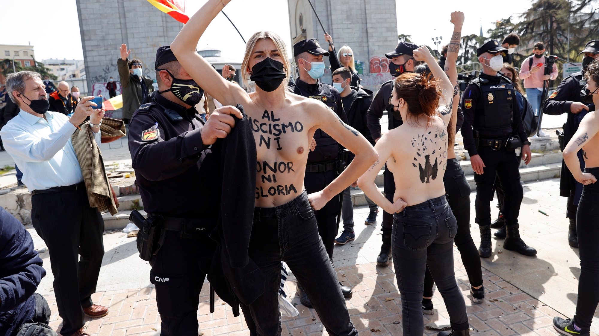 epa09102990 Femen activists shout slogans in front of a rally of Franco&#039;s dictatorship regimen followers in Madrid, Spain, 28 March 2021.  EPA/Zipi