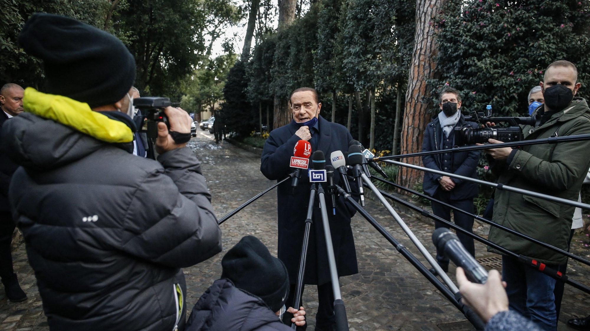 epa09655097 Forza Italia leader Silvio Berlusconi speaks to journalists at the end of the center-right summit at Villa Grande, Rome, Italy, 23 December 2021.  EPA/FABIO FRUSTACI