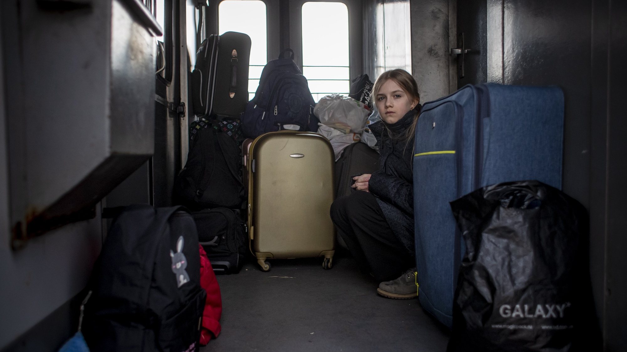 epa09801648 A girl sits on a train with people fleeing Ukraine to Poland by train, in Mostyska, Ukraine, 04 March 2022. According to the United Nations (UN), at least one million people have fled Ukraine to neighboring countries since the beginning of Russia&#039;s military aggression on 24 February 2022. The UN estimates that around 160,000 Ukrainians are currently internally displaced.  EPA/MARTIN DIVISEK
