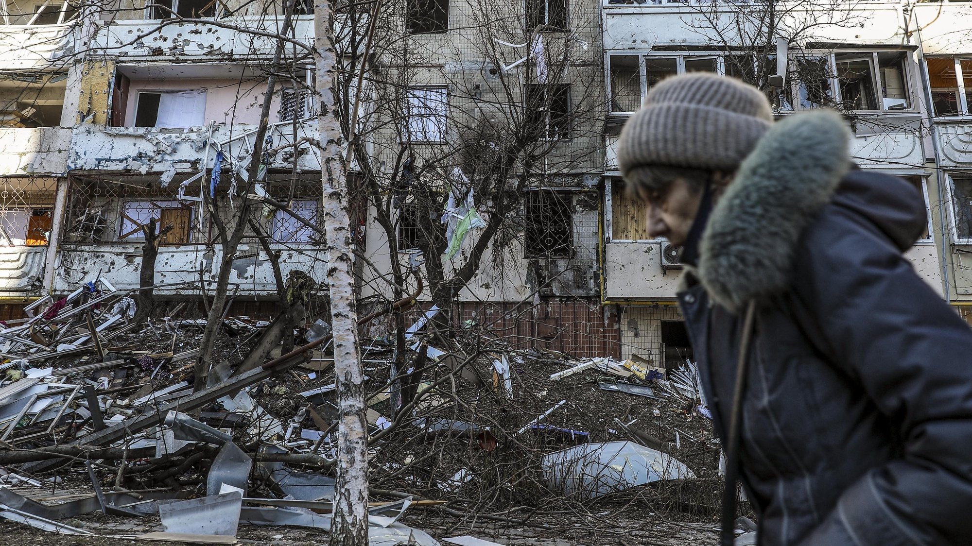 A woman passes by the debris of a building damaged by shelling in Kyiv as Russia&#039;s attack on Ukraine continues, 15 March 2022. Russian troops entered Ukraine on 24 February prompting the country&#039;s president to declare martial law and triggering a series of announcements by Western countries to impose severe economic sanctions on Russia. MIGUEL A. LOPES/LUSA