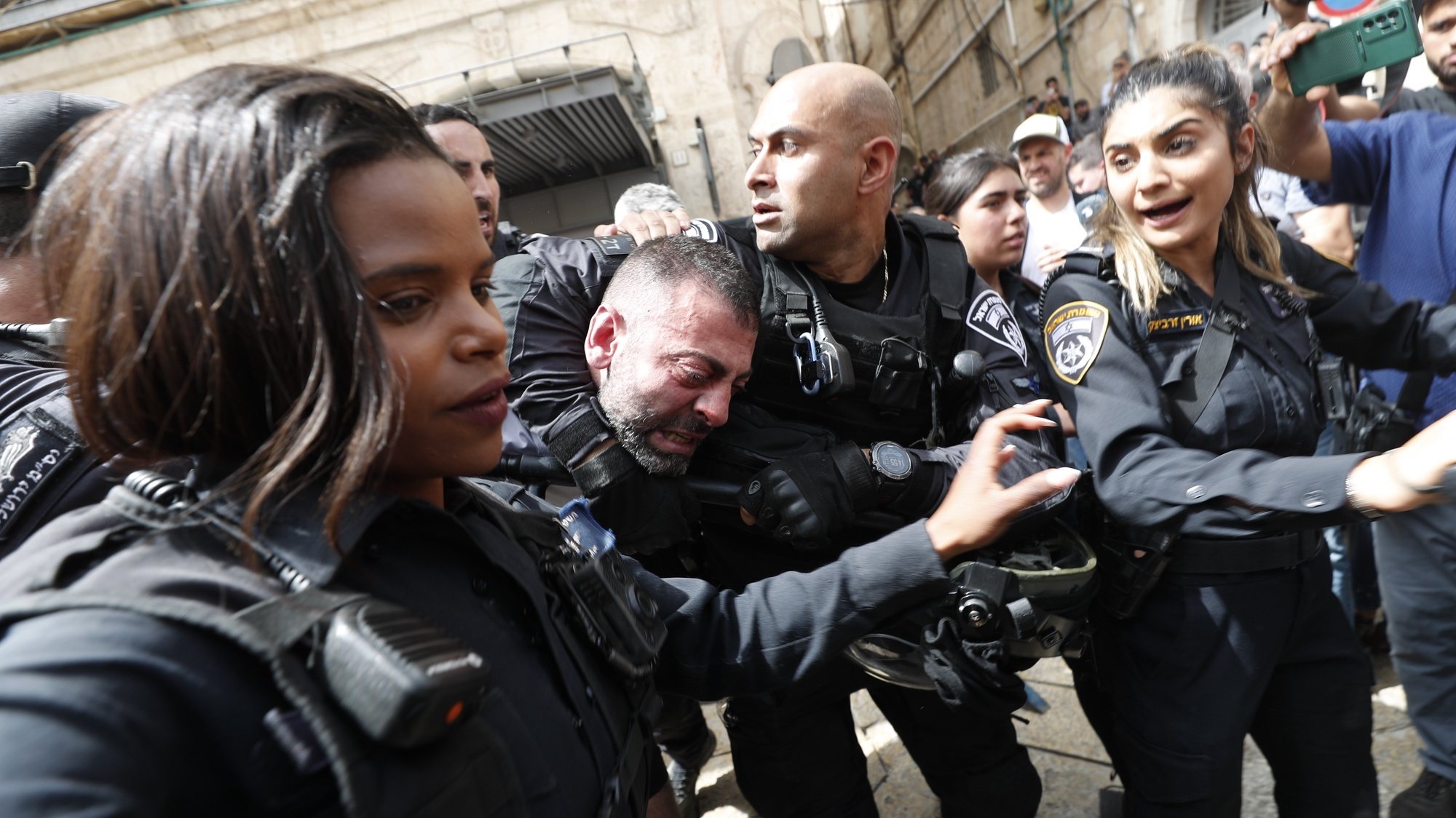 epa09944493 Israeli police arrest a man during a procession for slain American-Palestinian journalist Shireen Abu Akleh prior to her funeral, in the Old City of Jerusalem, 13 May 2022. Al Jazeera journalist Shireen Abu Akleh was killed on 11 May 2022 during a raid by Israeli forces in the West Bank town of Jenin.  EPA/ATEF SAFADI