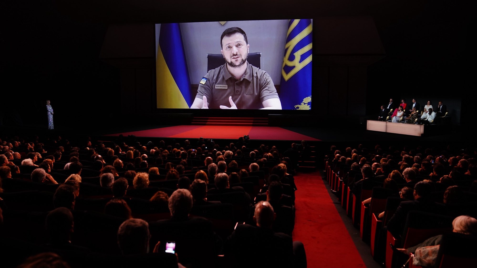 epaselect epa09953398 Ukraine&#039;s President Volodymyr Zelensky appears on a screen during the Opening Ceremony of the 75th annual Cannes Film Festival, in Cannes, France, 17 May 2022. The festival runs from 17 to 28 May.  EPA/CLEMENS BILAN