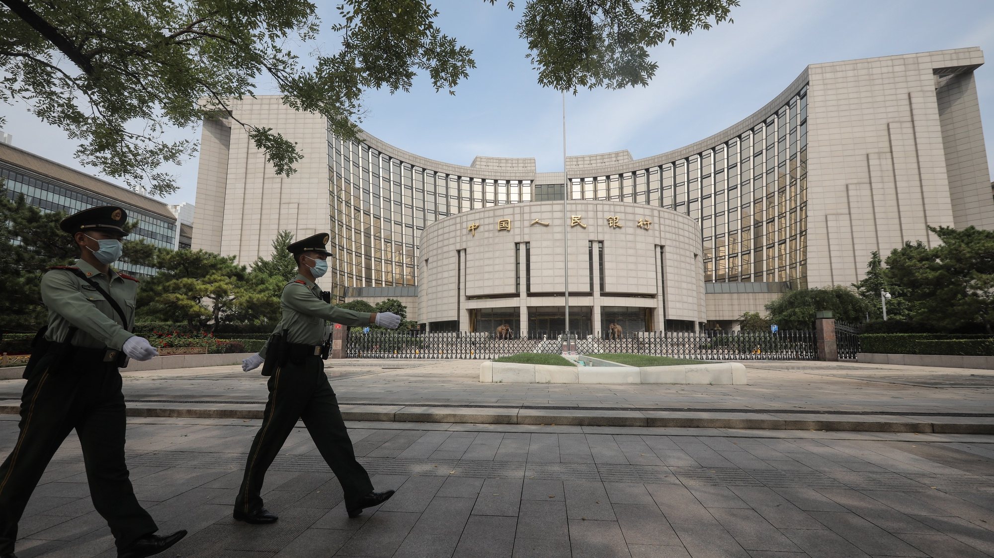 epa09486810 Officers of the People&#039;s Armed Police patrol past the headquarters of the People&#039;s Bank of China in Beijing, China, 25 September 2021. China&#039;s central bank and nine other government departments jointly announced a crackdown on illegal services and trading of virtual currencies on 24 September 2021.  EPA/WU HONG