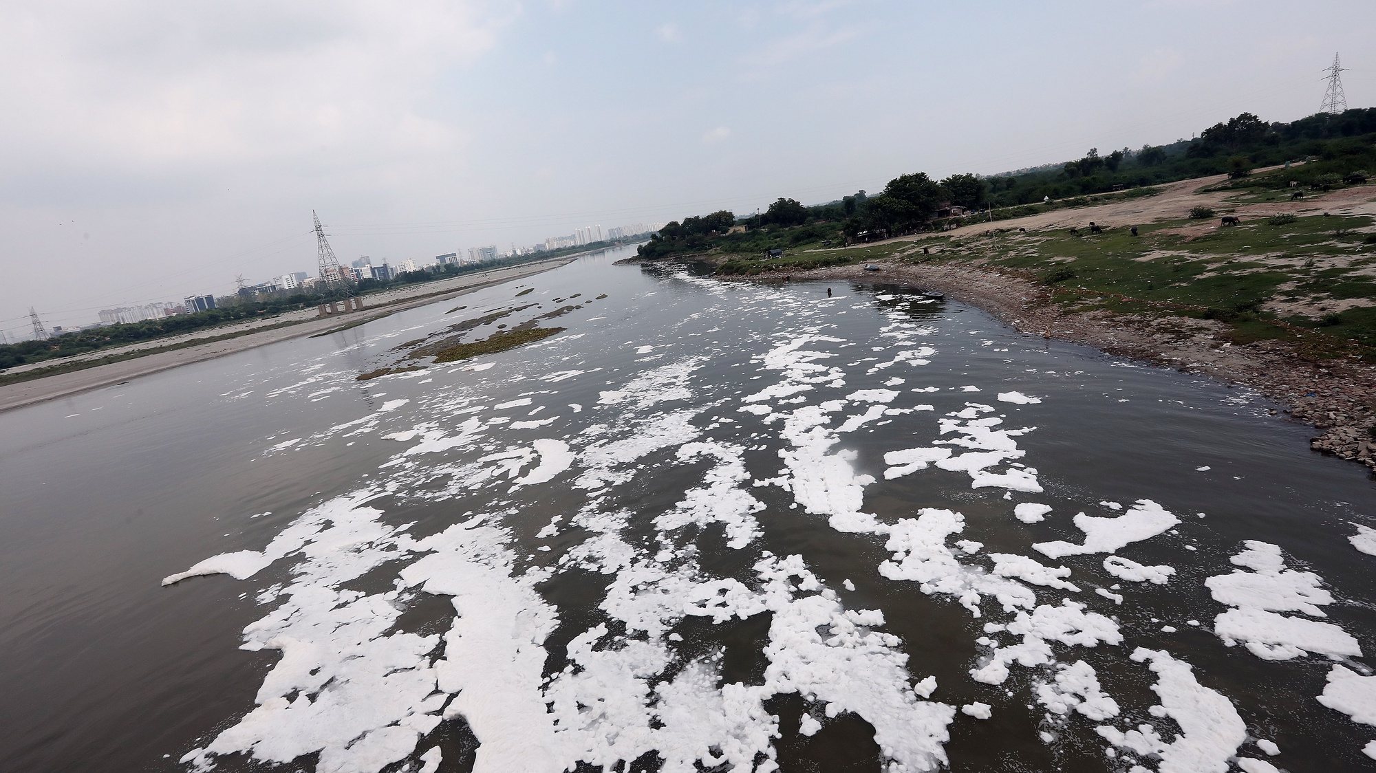 epa08589741 A general view of polluted Yamuna river that is covered with toxic foam caused by industrial waste in New Delhi, India, 07 August 2020. According to the news reports pollution returns to the river Yamuna after governments allowed relaxation in two months lockdown that was for prevent the spread of coronavirus and Covid 19.  EPA/HARISH TYAGI