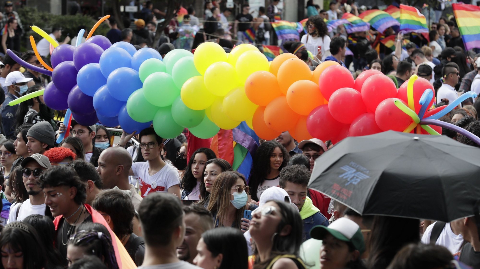 epa10050654 People participate in the LGBTIQ+ Pride march through the streets of Bogota, Colombia, 03 July 2022.  EPA/Carlos Ortega