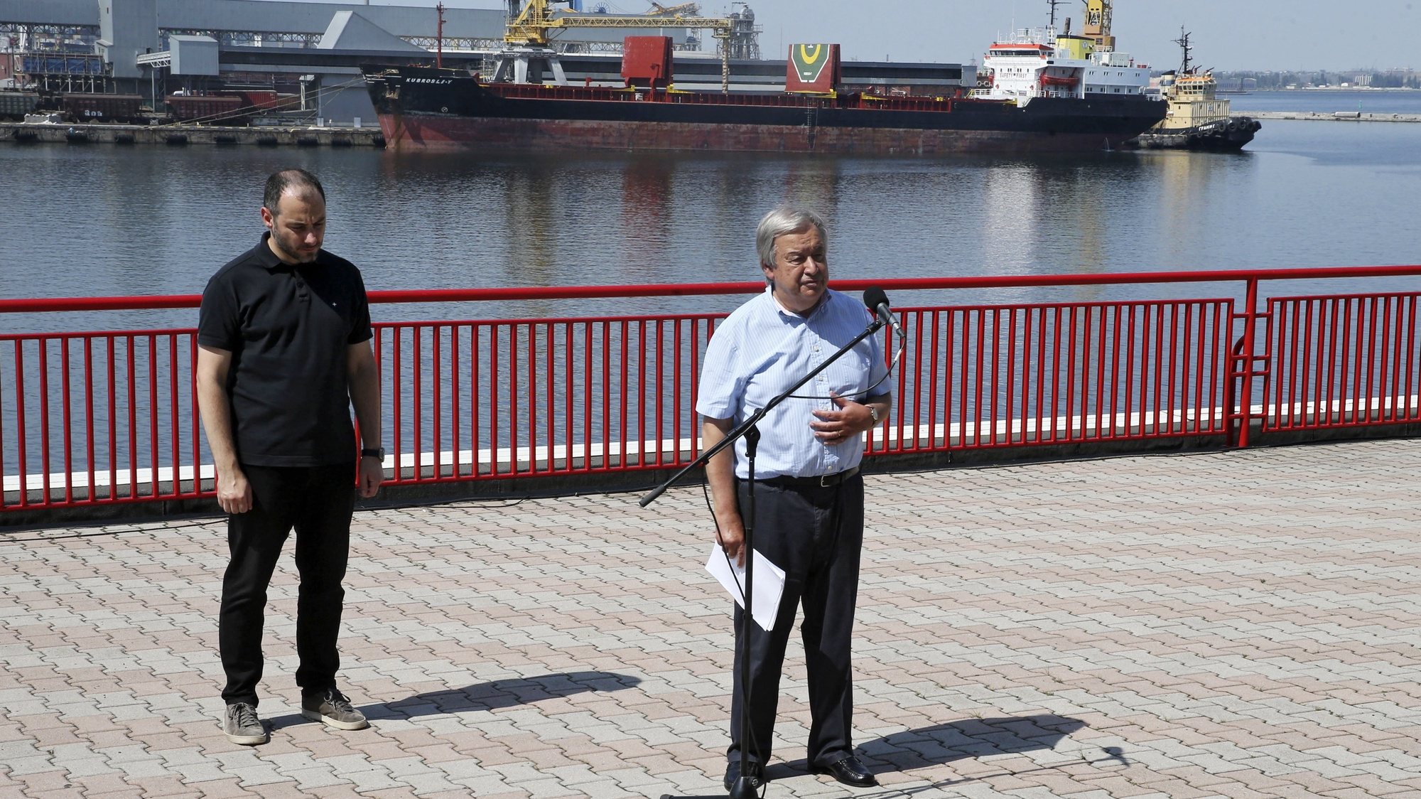 epa10128900 UN Secretary-General Antonio Guterres speaks to journalists at the end of his visit to the Odesa grain port, where in the background Comoros-flagged cargo vessel Kubrosli Y moors, in Odesa, Ukraine, 19 August 2022. Guterres arrived in Ukraine the previous dayto meet with President Zelensky and Turkish President Erdogan to talk on improving the grain initiative and the situation around the Zaporizhzhia nuclear power plant. The port of Odesa is being used for the export of Ukrainian grain through the Ukraine-Russia agreement promoted by the UN and Turkey. Russian troops on 24 February entered Ukrainian territory, starting a conflict that has provoked destruction and a humanitarian crisis.  EPA/MANUEL DE ALMEIDA