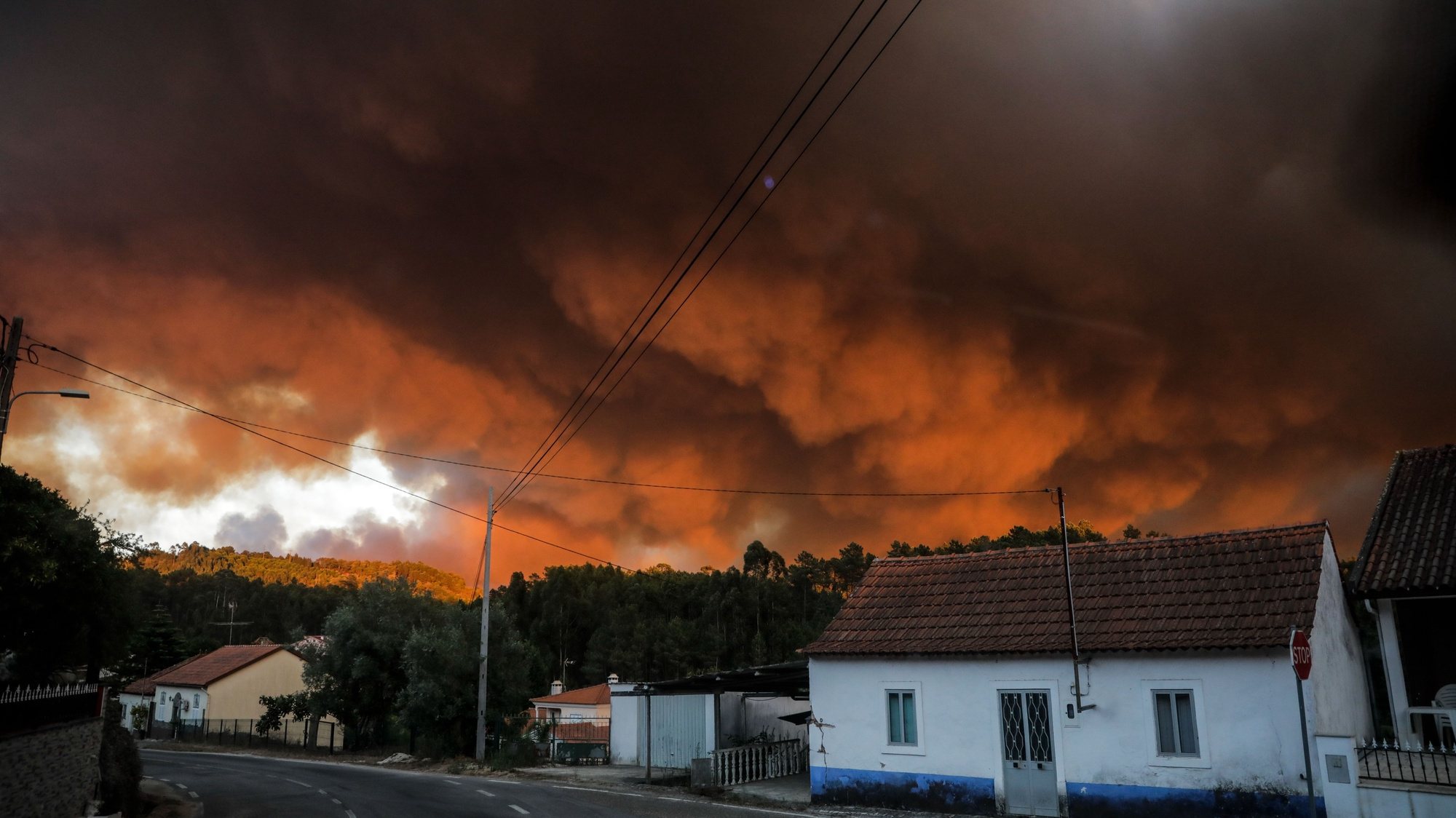 The sky covered with smoke due to a forest fire in the village of Urqueira, Ourem, Portugal, 19 August 2022. At least 50 people were taken out of their homes today, as a precaution, due to the fire that has been raging since 2:40 pm in the municipality of Ourem, district of Santarem. PAULO CUNHA/LUSA