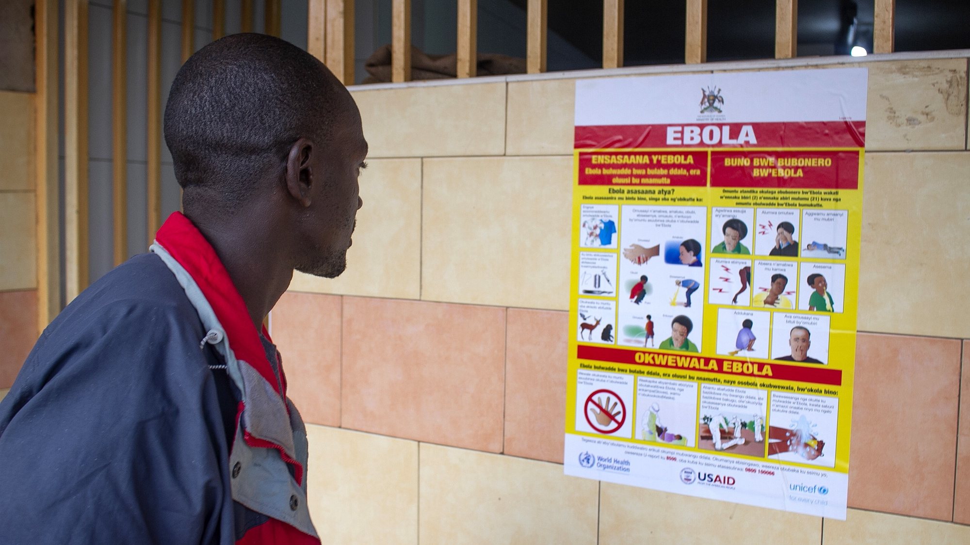 epa10212384 A man looks at an Ebola virus disease awareness campaign poster following an outbreak of Ebola in Uganda, in Kampala, Uganda, 28 September 2022. According to Uganda&#039;s Health Ministry, Ebola infections have risen across some districts in Uganda with the number of confirmed and suspected deaths at 36. The president addressed the nation on measures the government is putting in place to mitigate the spread.  EPA/Stringer