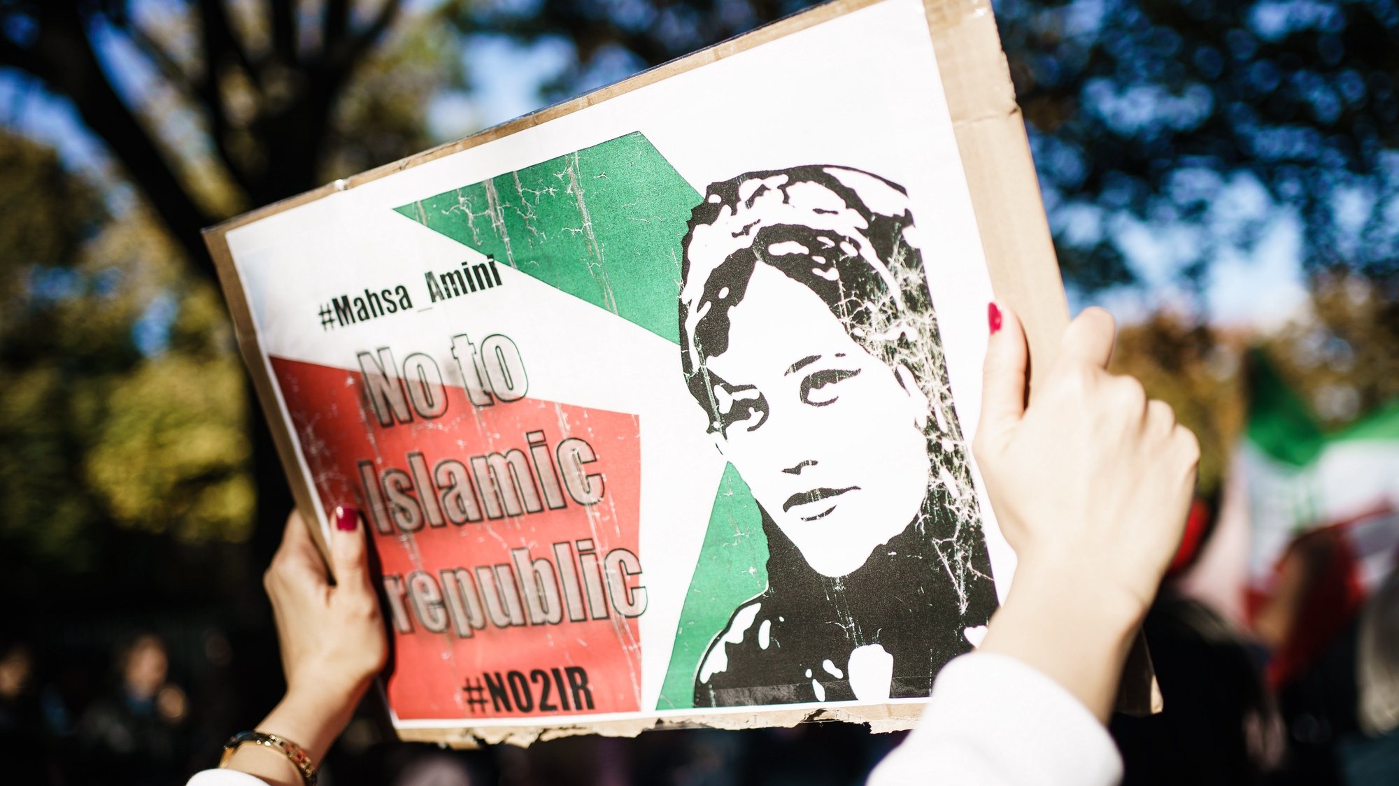 epa10259099 A female demonstrator holds a cardboard reading &#039;No to Islamic Republic&#039; during a rally in solidarity with Iranian protests following the death of Mahsa Amini, in Berlin, Germany, 22 October 2022. Amini, a 22-year-old Iranian woman, was arrested in Tehran on 13 September by the police unit responsible for enforcing Iran&#039;s strict dress code for women. She fell into a coma while in police custody and was declared dead on 16 September.  EPA/CLEMENS BILAN