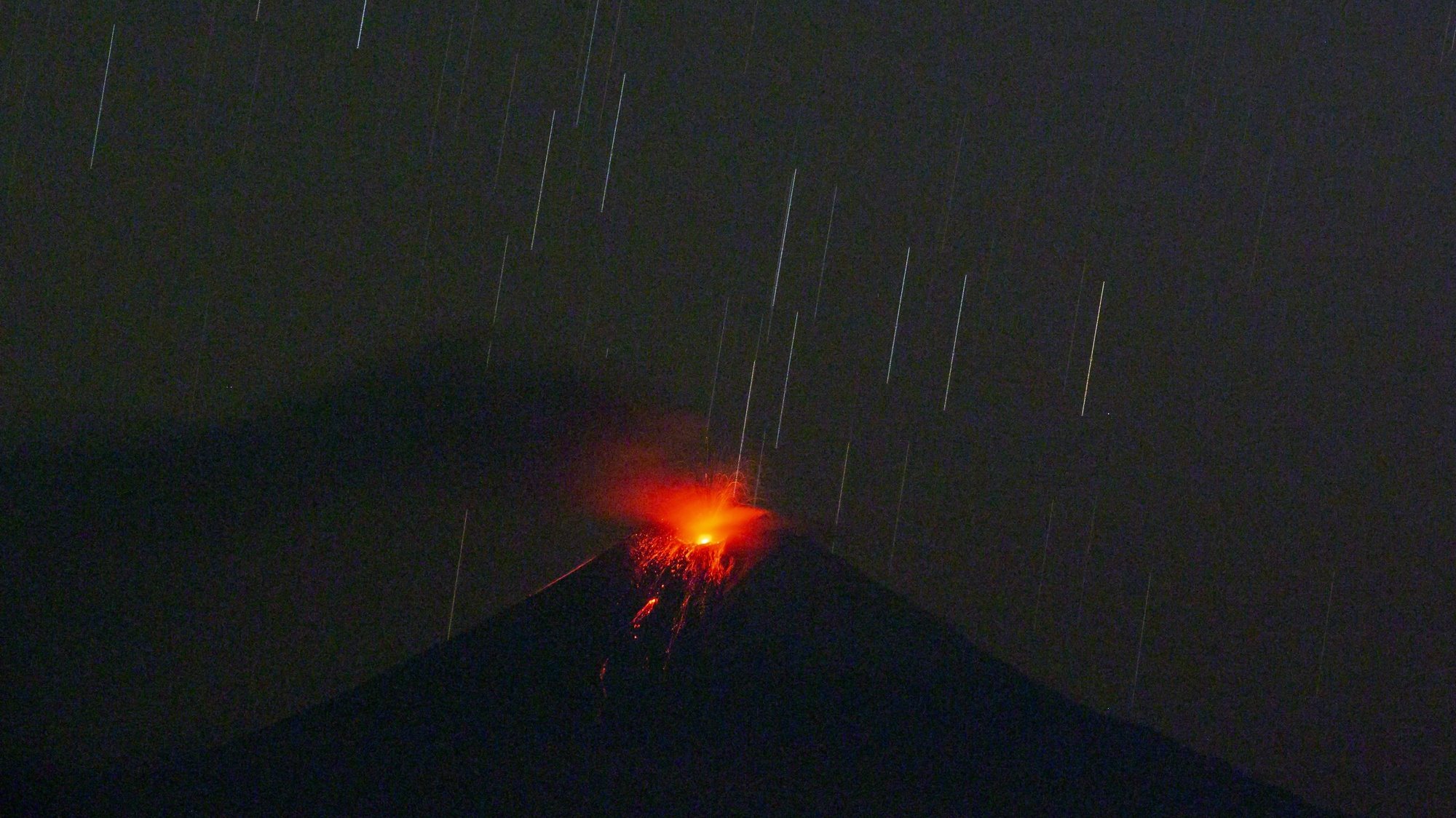 epa10141825 The eruptive activity of the Sangay volcano, from the San Isidro parish, in the Sangay National Park, in the city of Macas, Ecuador 27 August 2022.  EPA/Jose Jacome