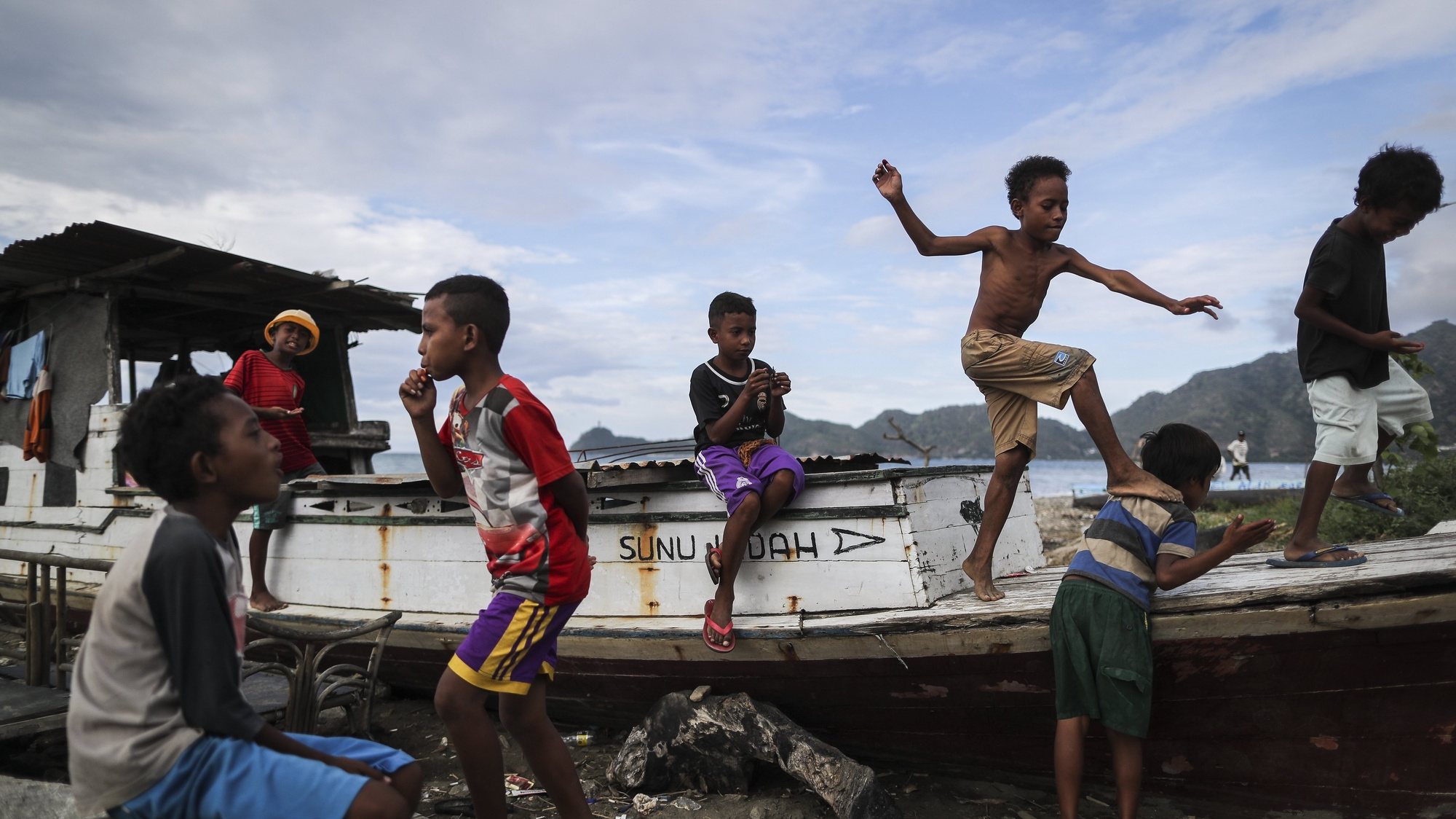 epa05857499 East Timorese young boys play on a broken boat at Bidau Lecidere beach in Dili, East Timor also known as Timor Leste, 19 March 2017. East Timor will hold the presidential election on 20 March 2017. The country gained their independence from Indonesia in 2002.  EPA/MAST IRHAM