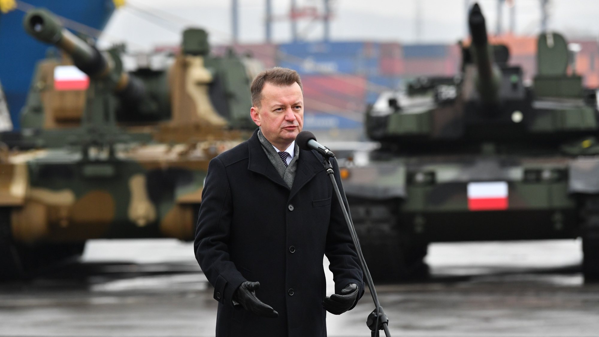 epa10351184 Polish Defence Minister Mariusz Blaszczak speaks during the delivery of South Korean K2 tanks and K9 howitzers for the Polish army at the Container Terminal in Gdynia, northern Poland, 06 December 2022. In July of this year, a framework agreement was concluded with Hyundai Rotem for the purchase of a total 1,000 K2 tanks. Polish Ministry of Defence, in addition, noted that &#039;a framework contract concluded with Hanwha Defence covers the purchase of a total of 672 self-propelled howitzers.&#039;  EPA/Adam WarÃ¸awa POLAND OUT