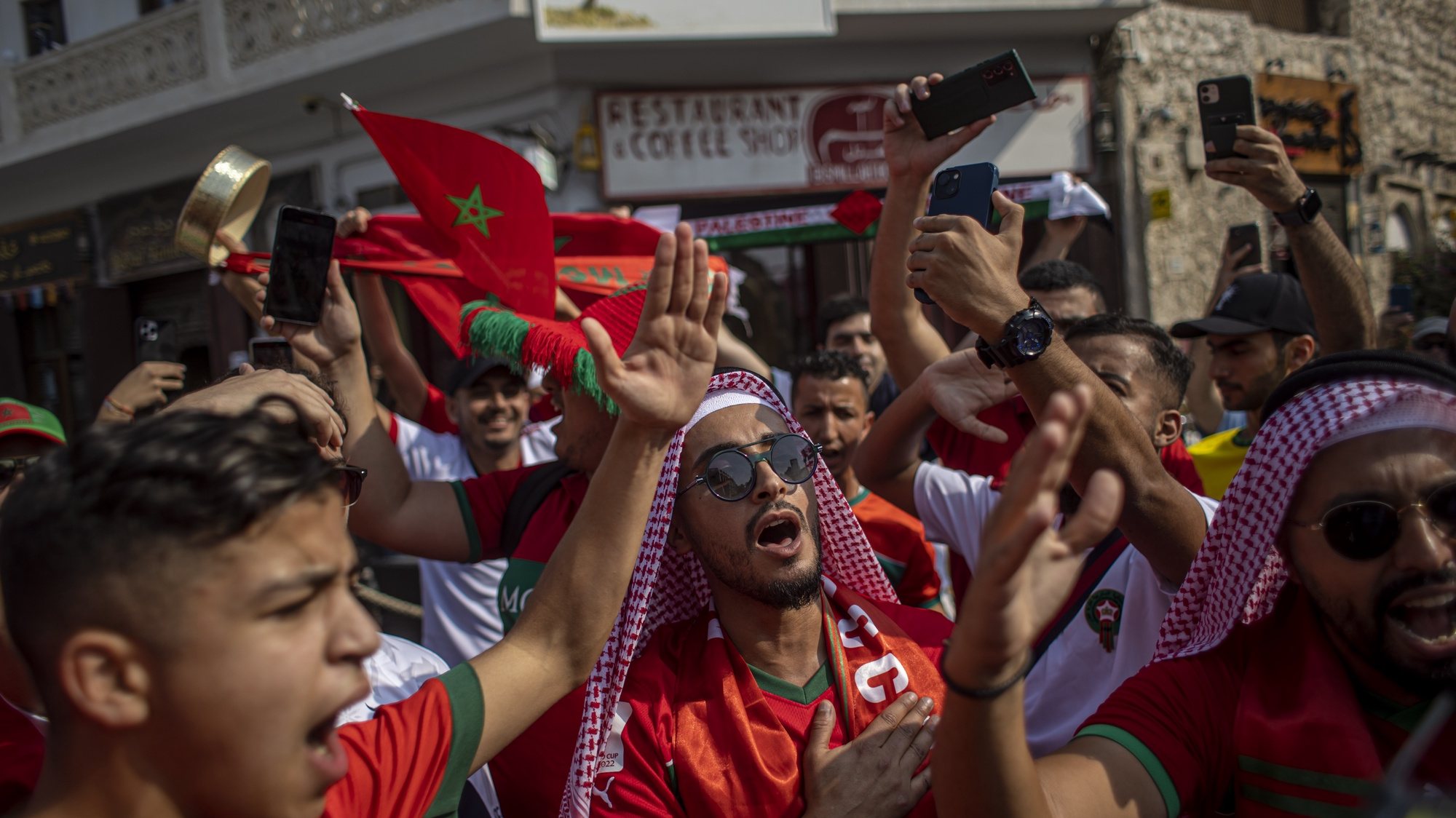 epa10351471 Fans of Morocco cheer at the traditional market Souq Waqif during the FIFA World Cup 2022 in Doha, Qatar, 06 December 2022. Morocco will face Spain in their FIFA World Cup 2022 round of 16 soccer match on 06 December.  EPA/MARTIN DIVISEK
