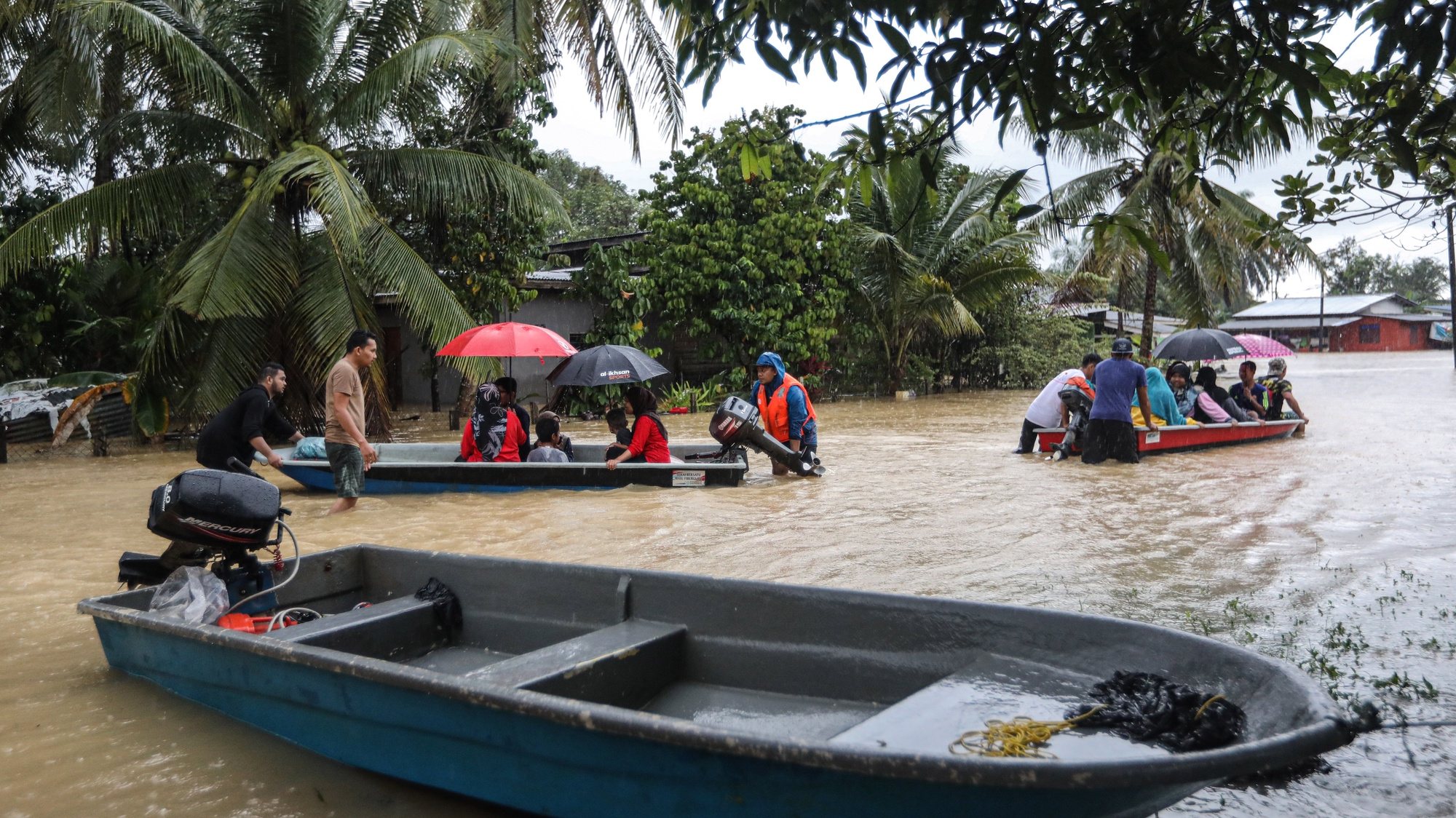 epa10375711 People use boats through a flooded area in Kuala Terengganu, Malaysia, 21 December 2022. According to Malaysian authorities, five people were killed and more than 70,000 were evacuated after monsoons triggered floods that inundated the state of Kelantan, Terengganu and Pahang.  EPA/STR