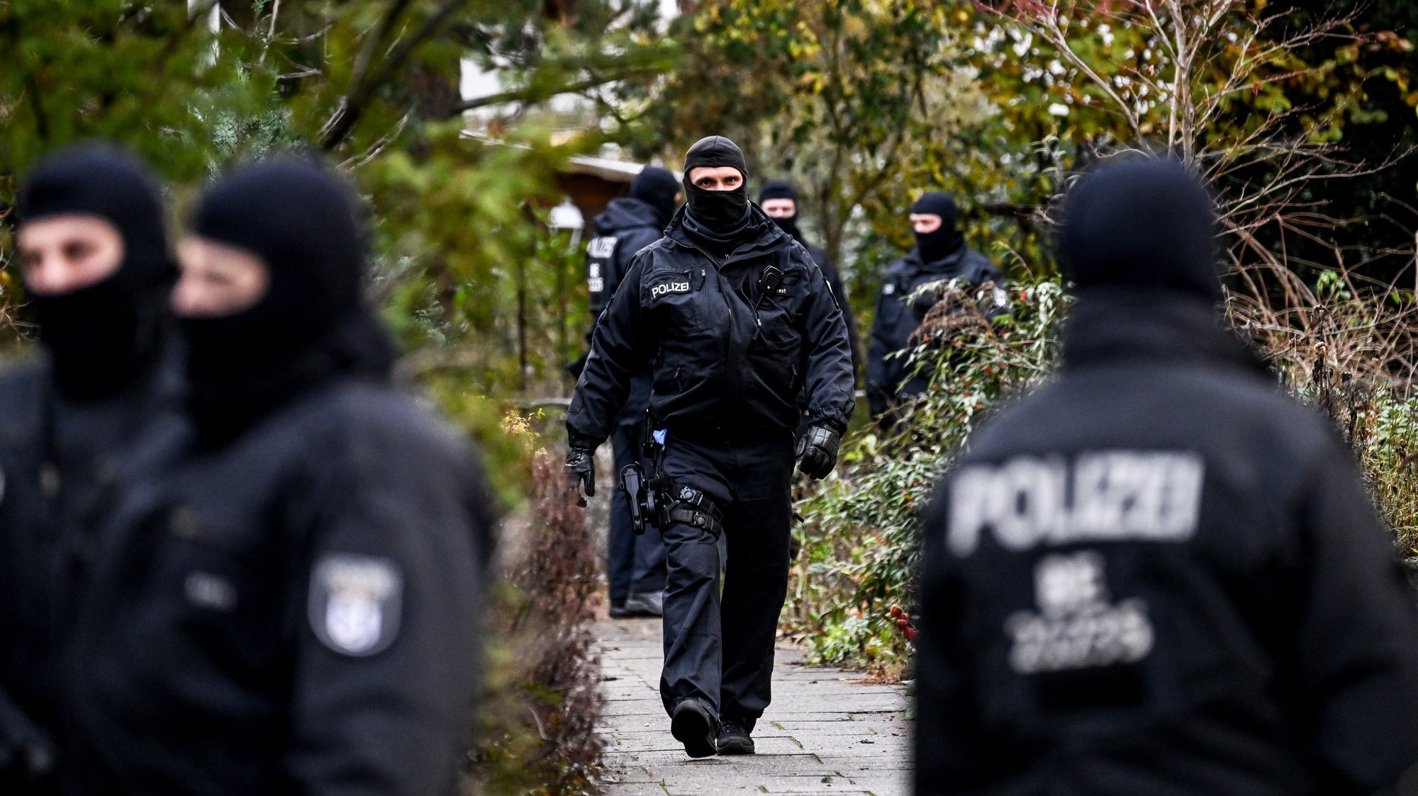 epa10353400 Police officers work during a raid in Berlin, Germany, 07 December 2022. Twenty-five people allegedly affiliated to the so-called Reichs Citizens (Reichsbuerger) movement were arrested in raids across Germany on suspicion of plotting to overthrow the government, a spokesperson for the Federal Prosecutor&#039;s office said. A group of far-right and ex-military figures are suspected to have planned to storm the parliament building, the Reichstag, and seize power.  EPA/FILIP SINGER