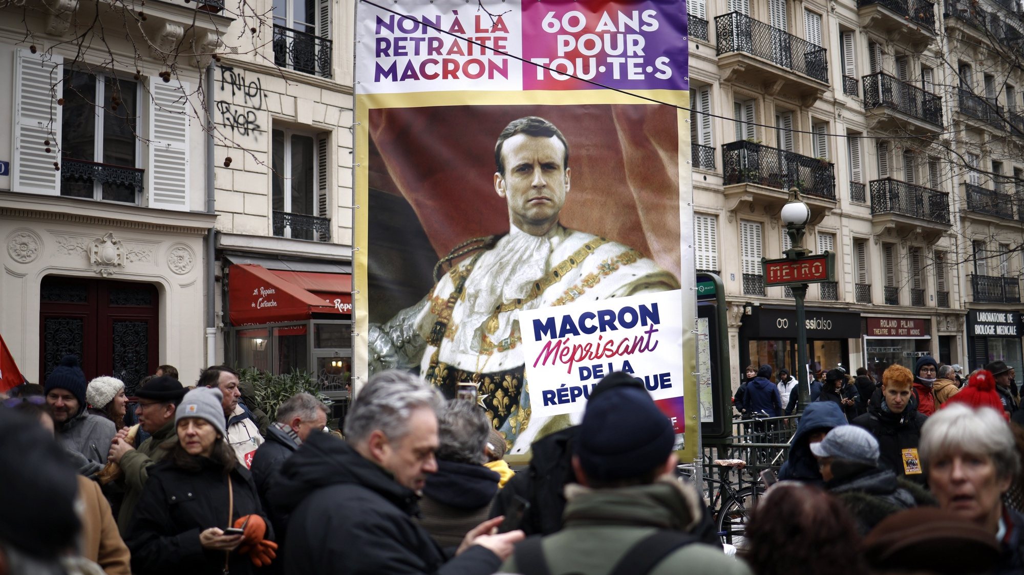 epa10415667 A protester holds a poster depicting French president Emmanuel Macron during a national strike against the government&#039;s reform of the pension system, in Paris, France, 19 January 2023. The French government plans to delay the minimum retirement age from 62 to 64 by 2030.  EPA/YOAN VALAT