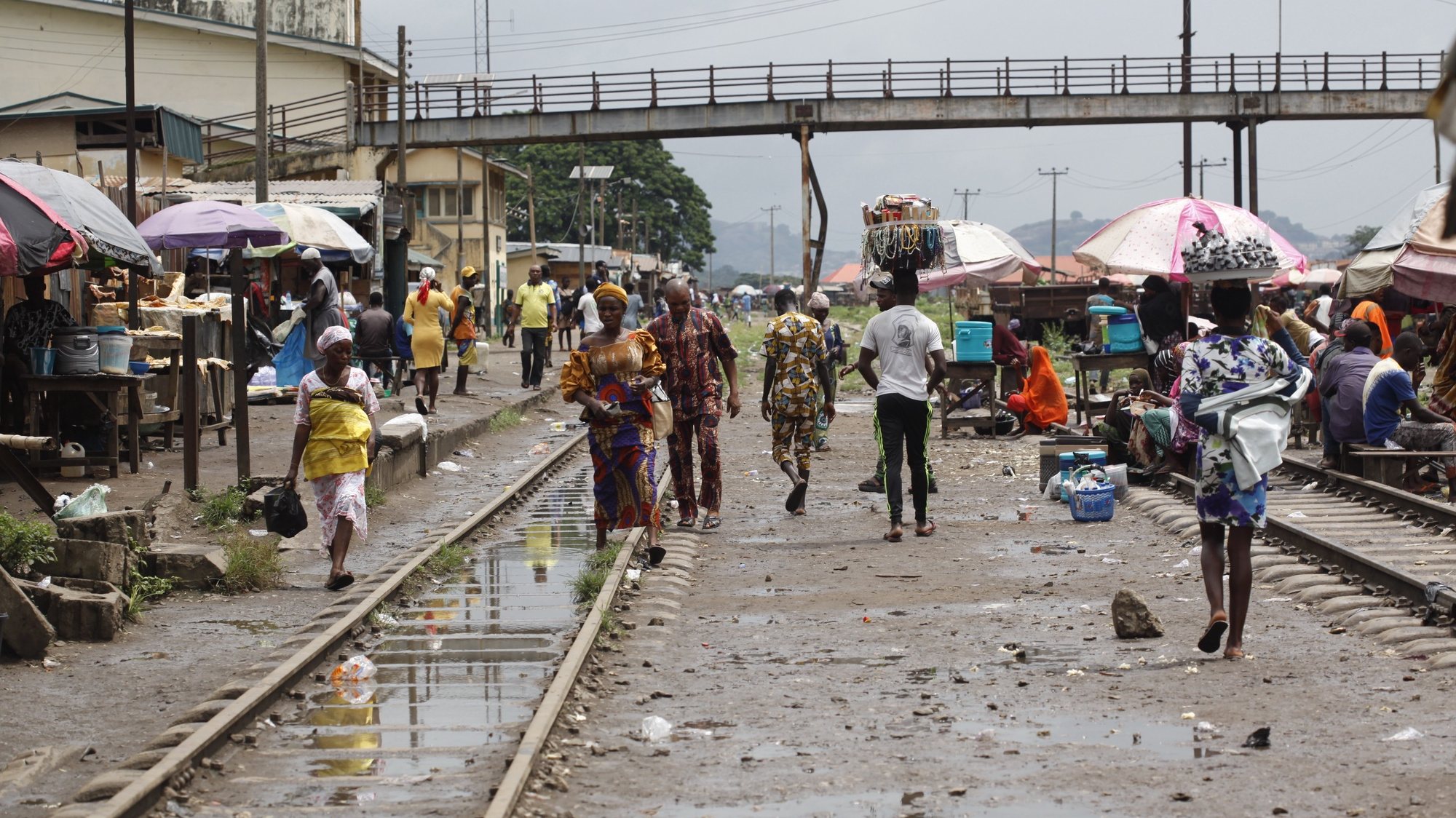 epa10307199 People walk through a slum near an abandoned train track in Abeokuta, about 70 kilometres outside Nigeria&#039;s commercial capital Lagos 15 November 2022. The global population is projected to reach 8 billion on 15 November 2022 . More than half of the projected increase in the global population up to 2050 will be concentrated in eight countries: the Democratic Republic of the Congo, Egypt, Ethiopia, India, Nigeria, Pakistan, the Philippines and the United Republic of Tanzania. Countries of sub-Saharan Africa are expected to contribute more than half of the increase anticipated through 2050, according to the United Nations&#039; report.  EPA/AKINTUNDE AKINLEYE