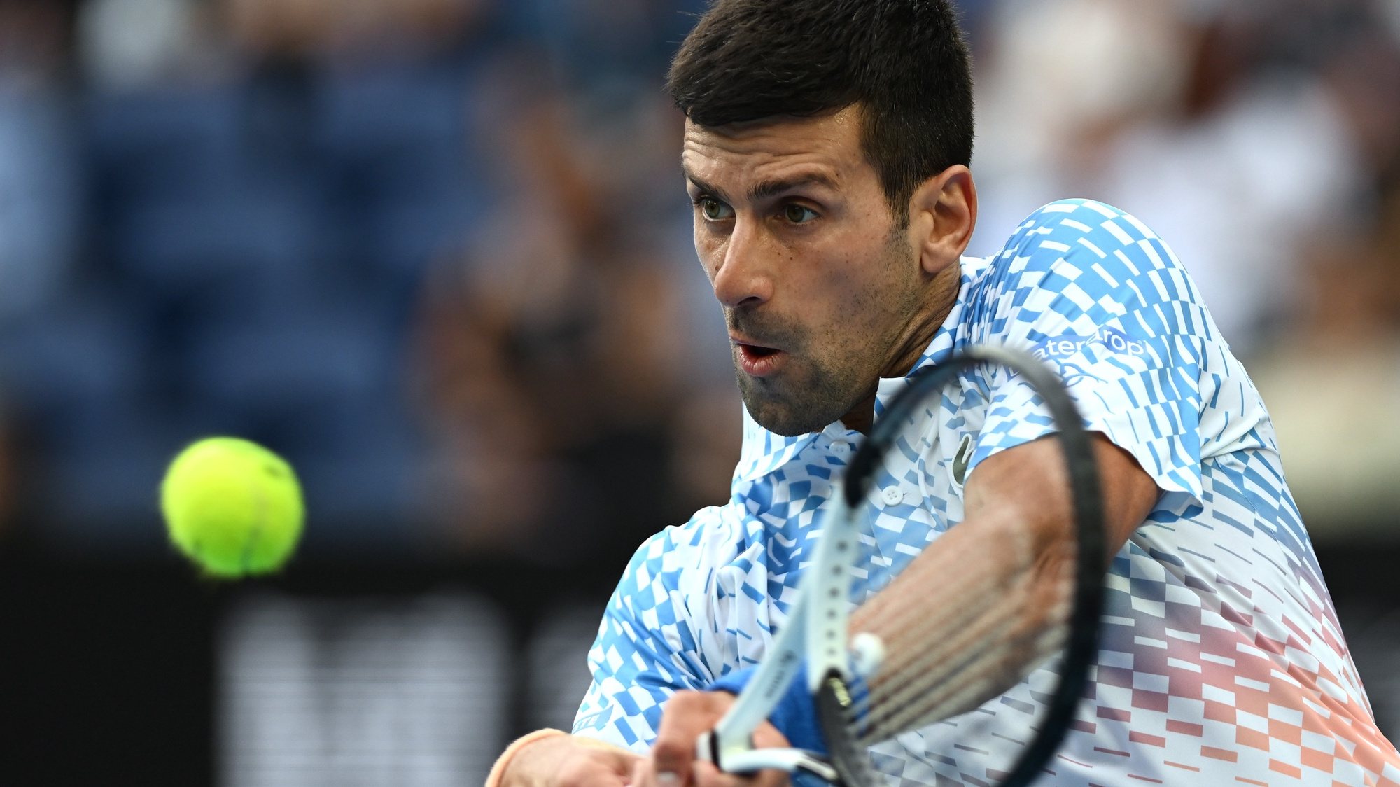 epa10419832 Novak Djokovic of Serbia in action against Grigor Dimitrov of Bulgaria during their third round match at the 2023 Australian Open tennis tournament in Melbourne, Australia, 21 January 2023.  EPA/LUKAS COCH  AUSTRALIA AND NEW ZEALAND OUT