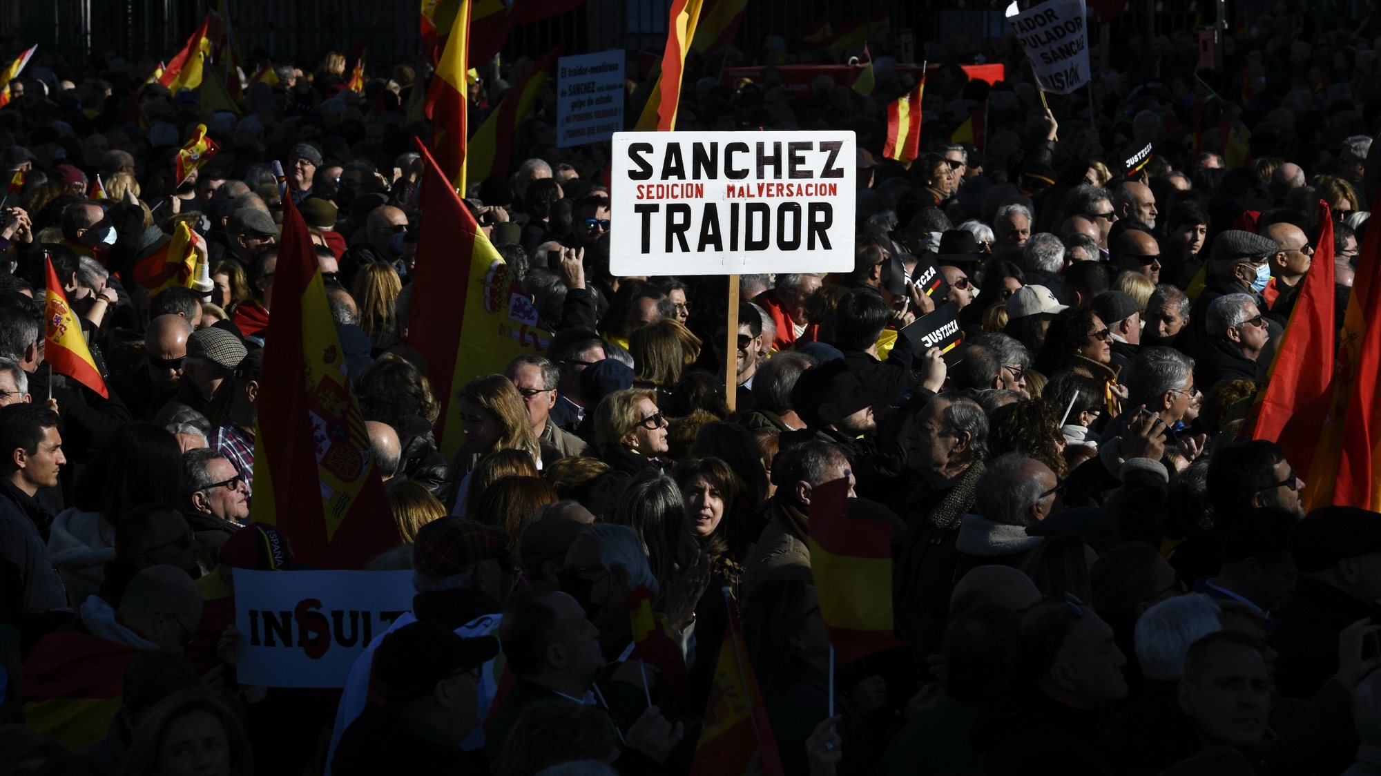 epa10420271 A demonstrator holds a banner reading &#039;Sanchez Treacherous. Sedition embezzlement&#039; as some thousand people attend a rally against Spanish Prime Minister Pedro Sanchez&#039; policies and in defense of the Spanish Constitution, in downtown Madrid, Spain, 21 January 2023.  EPA/Victor Lerena