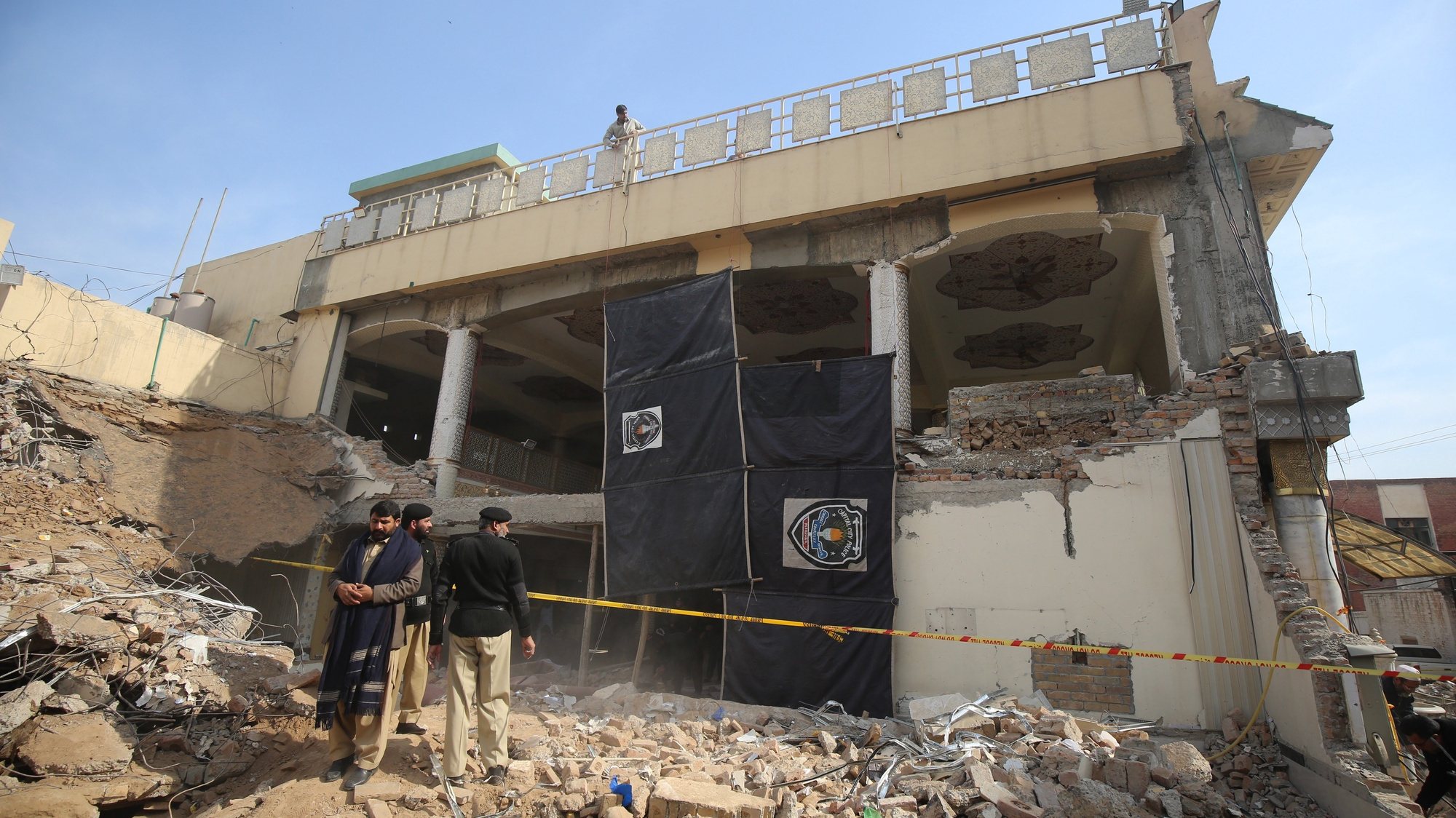 epa10443124 Police inspect the site of a Mosque that was destroyed in a suicide bomb blast on 30 January, in Peshawar, Pakistan, 01 February 2023. The Pakistani government is evaluating the possibility of launching a large-scale operation against the local Taliban offshoot in response to the brutal bombing at a mosque in Peshawar which killed at least 100 people, most of them police officers, as part of a steady deteriorating security landscape in the country with terrorism on the rise. Defense Minister Khawaja Asif had urged all parties in the National Assembly to unite against terrorism and launch an operation against the Taliban similar to a 2014 offensive.  EPA/ARSHAD ARBAB