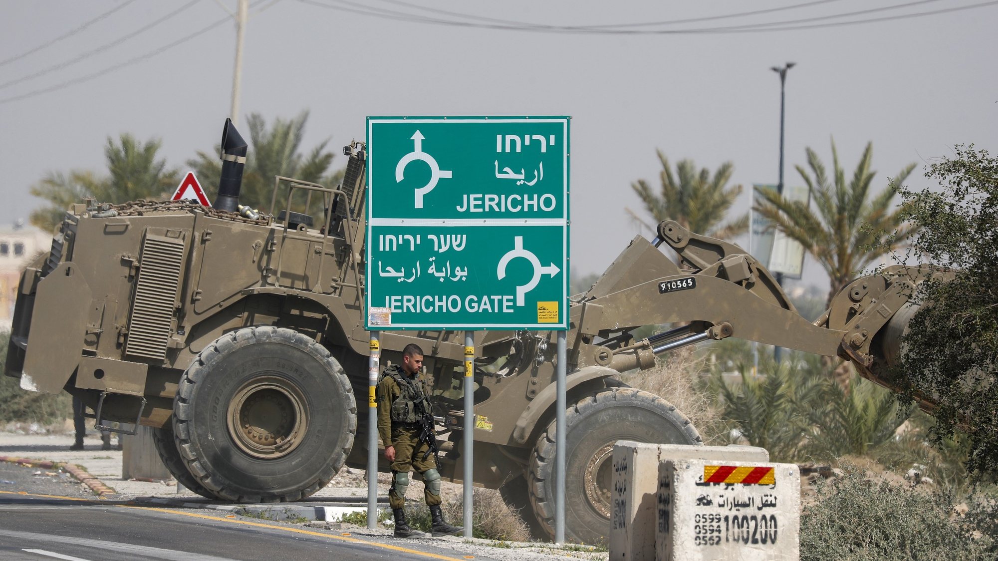 epa10495398 An Israeli military bulldozer blocks a road leading to the West Bank city of Jericho, 28 February 2023, as Israeli forces tighten security in the area. Israeli authorities said that an Israeli-American motorist was killed in a shooting attack by suspected Palestinian gunmen on Highway 90 near Jericho late 27 February. Israeli security forces have been conducting searches in the area and set up road blocks and checkpoints as they continue a manhunt for a number of attackers who killed three Israelis in recent shooting attacks in the West Bank.  EPA/ATEF SAFADI