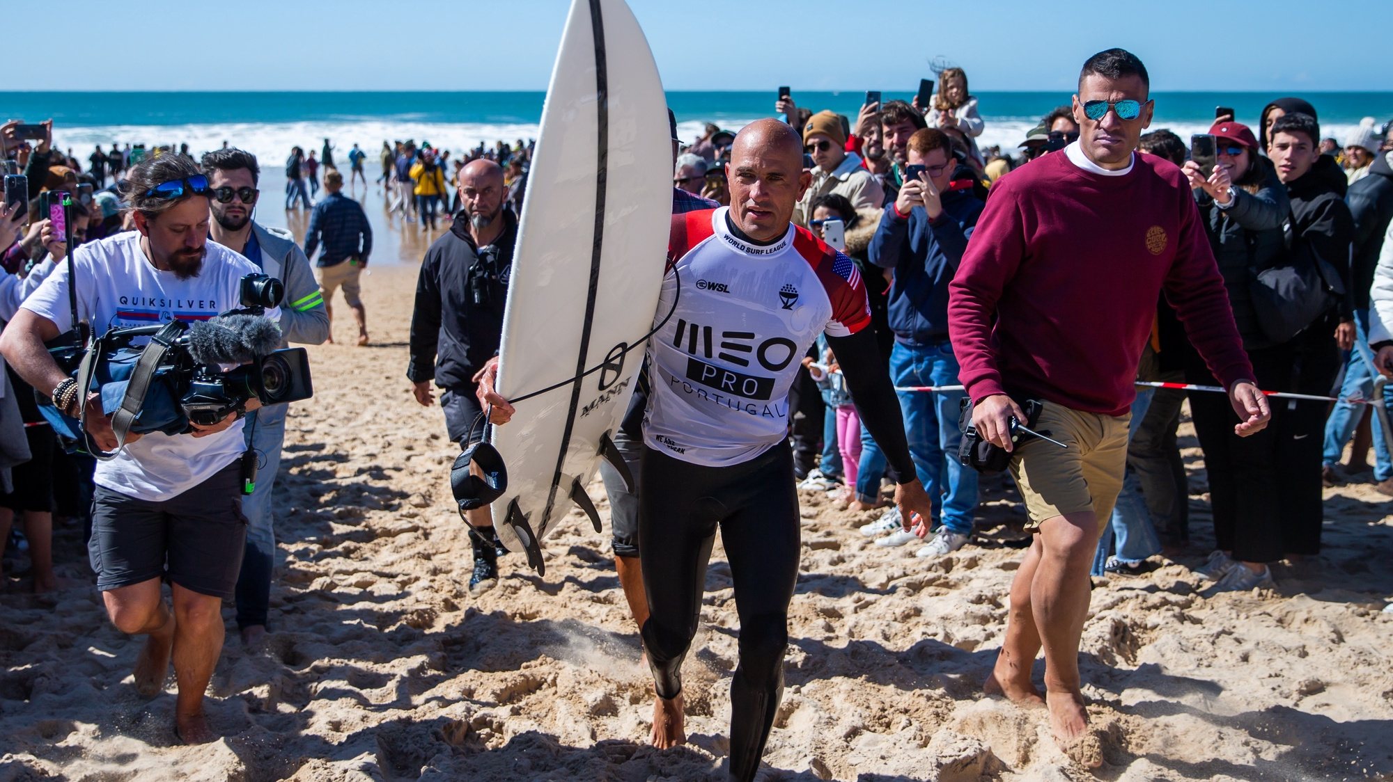 epa09805609 US surfer Kelly Slater walks up the beach after losing his round of 16 heat at the Meo Pro Portugal surfing event as part of the World Surf League (WSL) World Tour at Supertubos beach in Peniche, Portugal, 06 March 2022.  EPA/JOSE SENA GOULAO