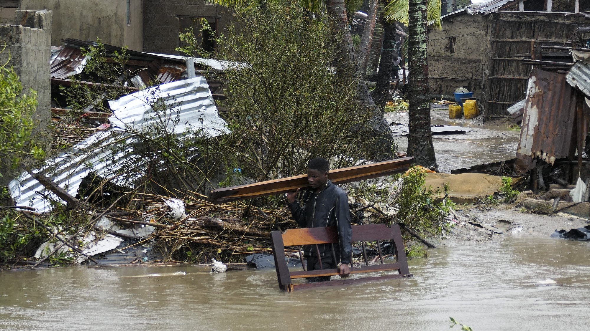 A man collects some wood on a flooded street near Quelimane, as the storm Freddy hits Mozambique, 12 March 2023. The provincial capital of Quelimane will be the largest urban area closest to the cyclone&#039;s point of arrival on the mainland, and its radius (of about 300 kilometres) is expected to extend from Marromeu to Pebane, then moving inland towards Cherimane and southern Malawi. This is one of the longest lasting storms ever, after it formed at the beginning of February in the Asian seas, crossing the entire Indian Ocean to the east African coast. ANDRE CATUEIRA/LUSA