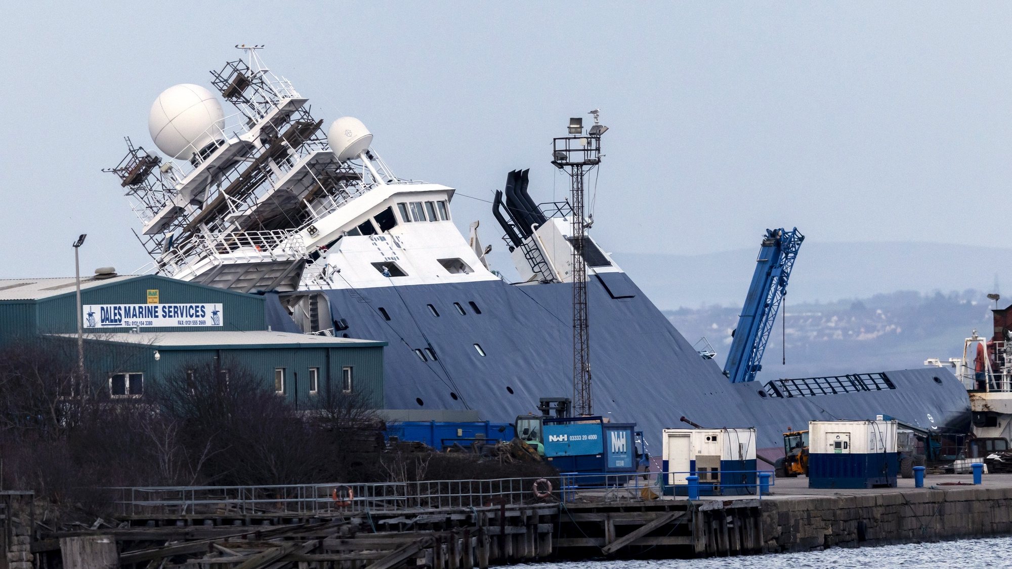 epa10537336 The RV Petrel ship toppled to the side at Imperial Dock in Leith, Edinburgh, Scotland, Britain, 22 March 2023. RV Petrel, a research vessel which was previously owned by the estate of late Microsoft co-founder Paul Allen, dislodged in its dry dock leaving 33 people injured, according to Scottish Ambulance Service.  EPA/ROBERT PERRY
