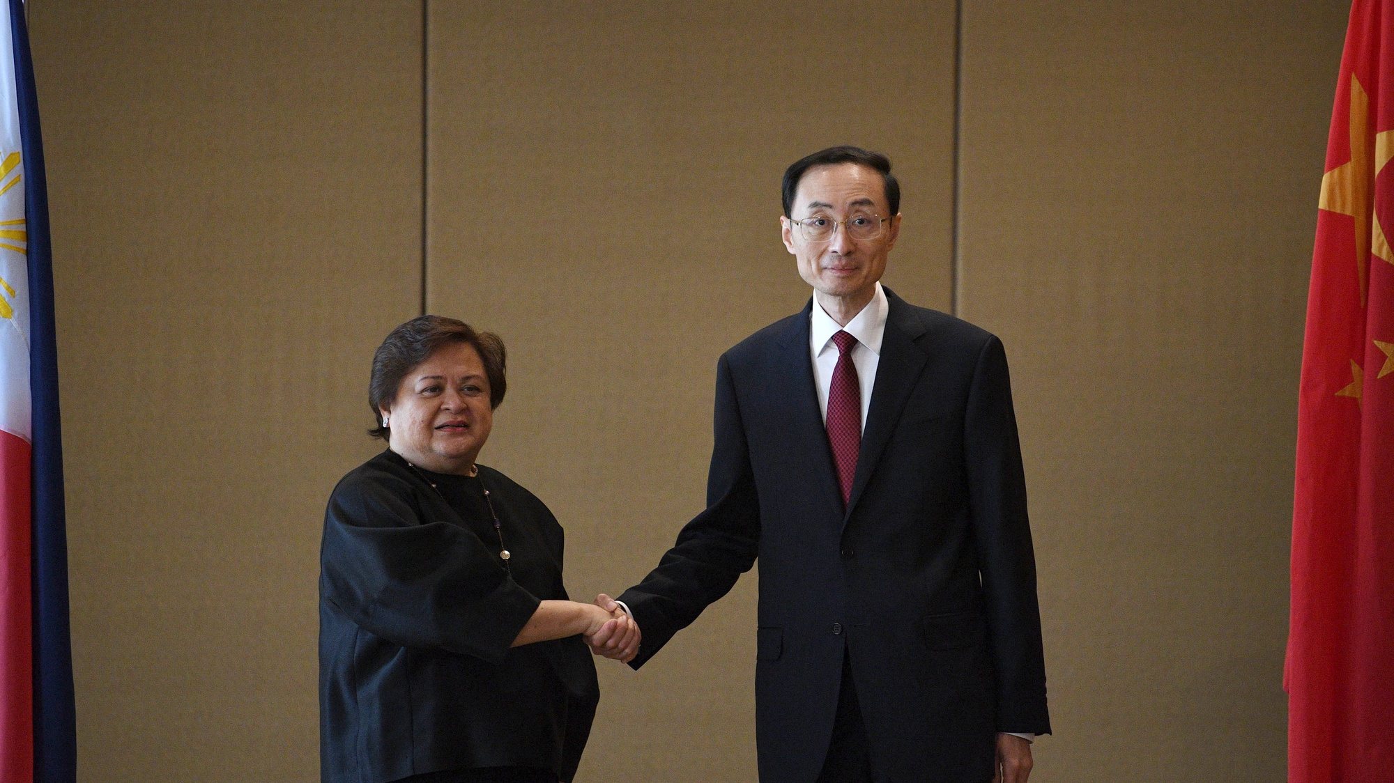 epa10537997 Filipino Foreign Affairs Undersecretary Maria Lourdes Lazaro (L) and Chinese Vice Foreign Minister Sun Weidong shake hands during a bilateral meeting in Manila, Philippines, 23 March 2023. Officials from Manila and Beijing hold the 23rd Philippines-China Foreign Ministry Consultations (FMC) and the 7th Bilateral Consultations Mechanism (BCM) on the South China sea to discuss maritime issues and to explore possible maritime cooperation.  EPA/TED ALJIBE/ POOL