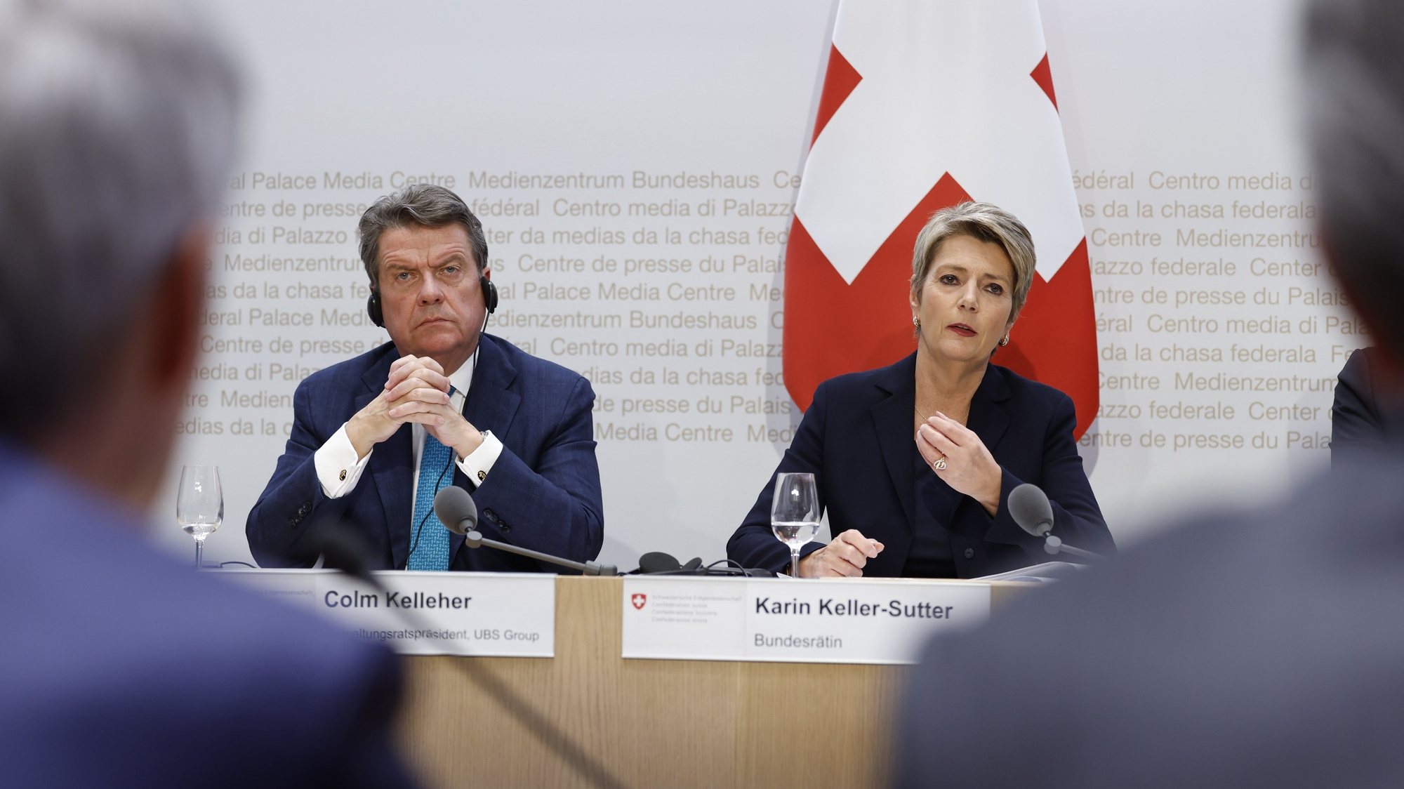 epa10532774 Swiss Finance Minister Karin Keller-Sutter (R), speaks next to Colm Kelleher (L), Chairman UBS, during a press conference in Bern, Switzerland, 19 March 2023. The bank UBS takes over Credit Suisse for 2 billion US dollars. Shares of Credit Suisse lost more than one-quarter of their value on 15 March 2023, hitting a record low after its biggest shareholder, the Saudi National Bank, told outlets that it would not inject more money into the ailing Swiss bank.  EPA/PETER KLAUNZER