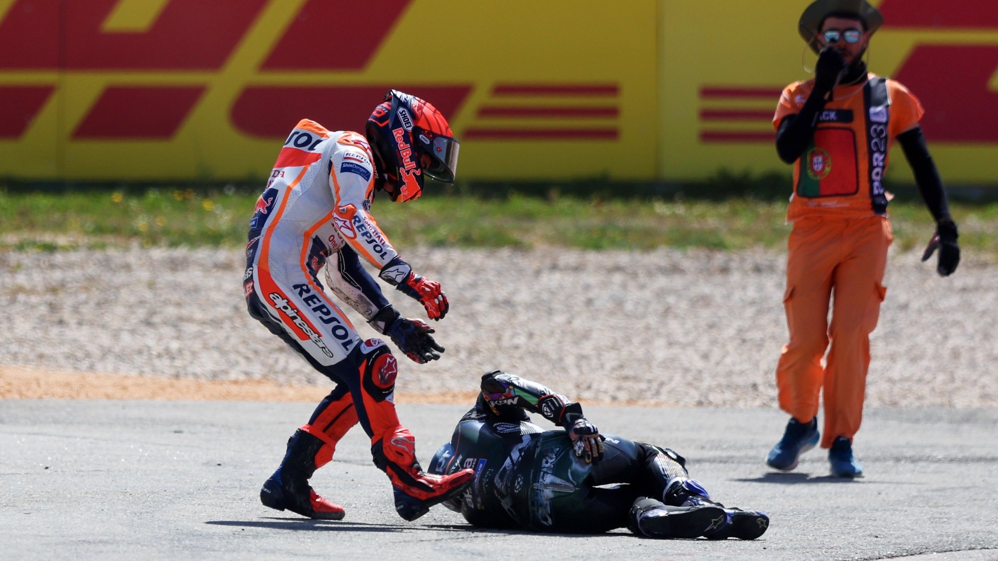 Spanish MotoGP rider Marc Marquez (L) of Repsol Honda Team tries to help Portuguese MotoGP rider Miguel Oliveira of CryptoDATA RNF MotoGP Team after a crash during the MotoGP race at the Motorcycling Grand Prix of Portugal at Algarve International race track, Portimao, south of Portugal, 26 March 2023. NUNO VEIGA/LUSA