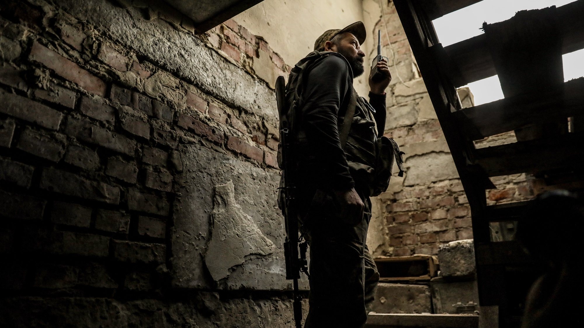 epa10650875 A Ukrainian serviceman from the 24th Separate Mechanized Brigade &#039;King Danylo&#039; holds a radio inside a building at a frontline position, at an undisclosed location in the Donetsk region, eastern Ukraine, 24 May 2023, amid the Russian invasion. Most of the town&#039;s some 10,000 inhabitants have deserted it because of the conflict. Some of the houses were destroyed while others are still standing. In its streets, pets, a few individuals can be seen while police and some communal services still continue to function. Russian troops entered Ukraine on 24 February 2022 starting a conflict that has provoked destruction and a humanitarian crisis.  EPA/OLEG PETRASYUK