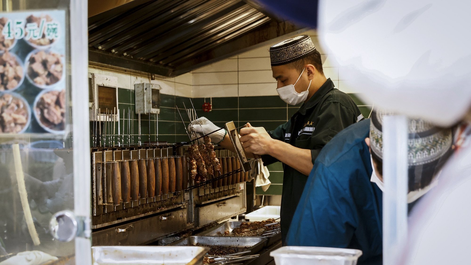 epa10676902 A man prepares lamb skewers at a food stall in Beijing, China, 06 June 2023 (Issued 07 June 2023). China&#039;s trade surplus dropped to 65.81 billion from 78.40 billion US dollars in May 2023, below market forecasts of 92 billion US dollars as exports fell more than imports, amid persistent weak global demand.  EPA/MARK R. CRISTINO