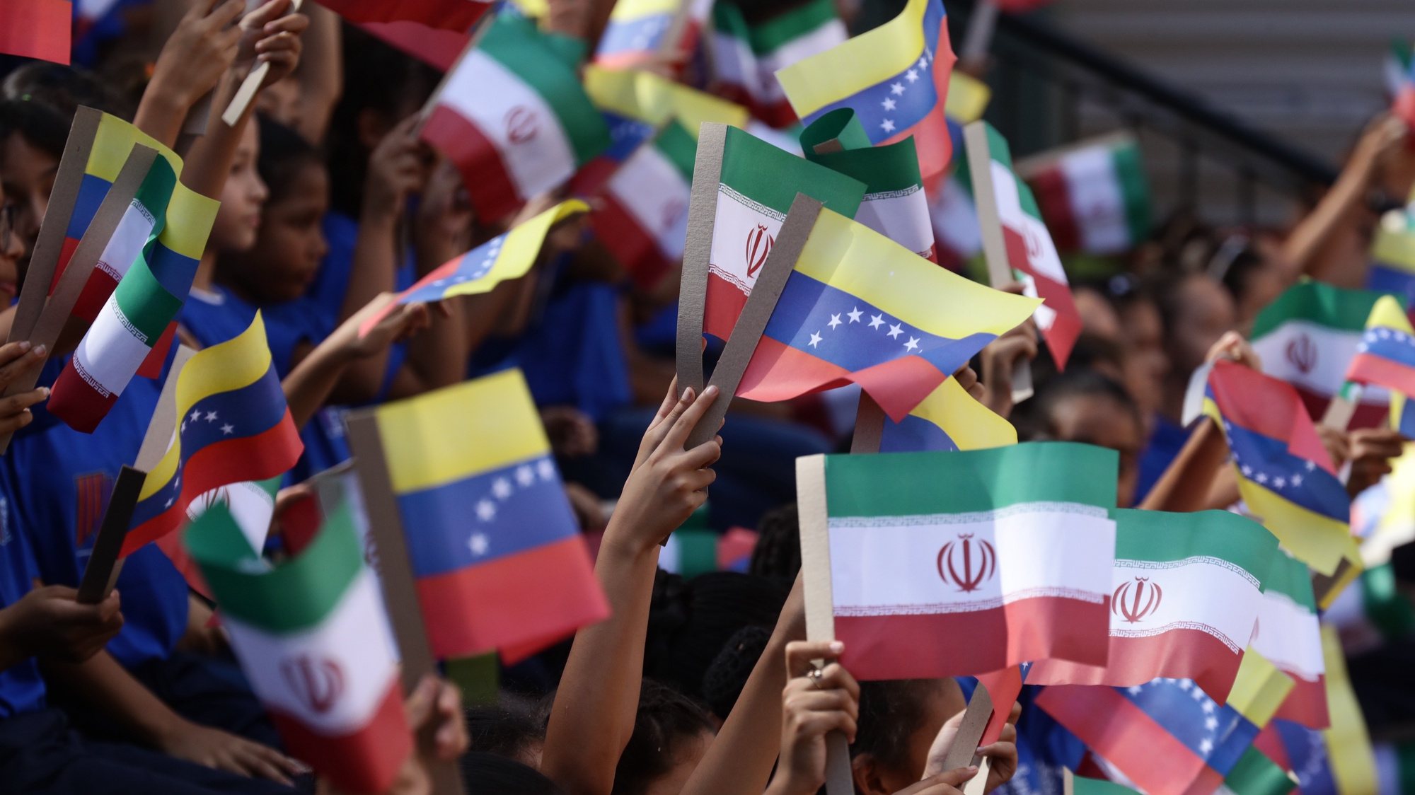 epa10687484 Children wave Venezuelan and Iranian flags to welcome the President of Iran, Ebrahim RaisÃ­, at the Miraflores presidential palace, in Caracas, Venezuela, on 12 June 2023, where Venezuelan President Nicolas Maduro is expected to receive him. Raisi landed this 12 June in Venezuela, at the Simon Bolivar International Airport, in Maiquetia, which serves Caracas, where he was received with honors by a delegation headed by Venezuelan Foreign Minister Yvan Gil. Venezuela is the first stop for the Iranian president on his tour of Latin America, which also includes Cuba and Nicaragua.  EPA/Rayner Pena