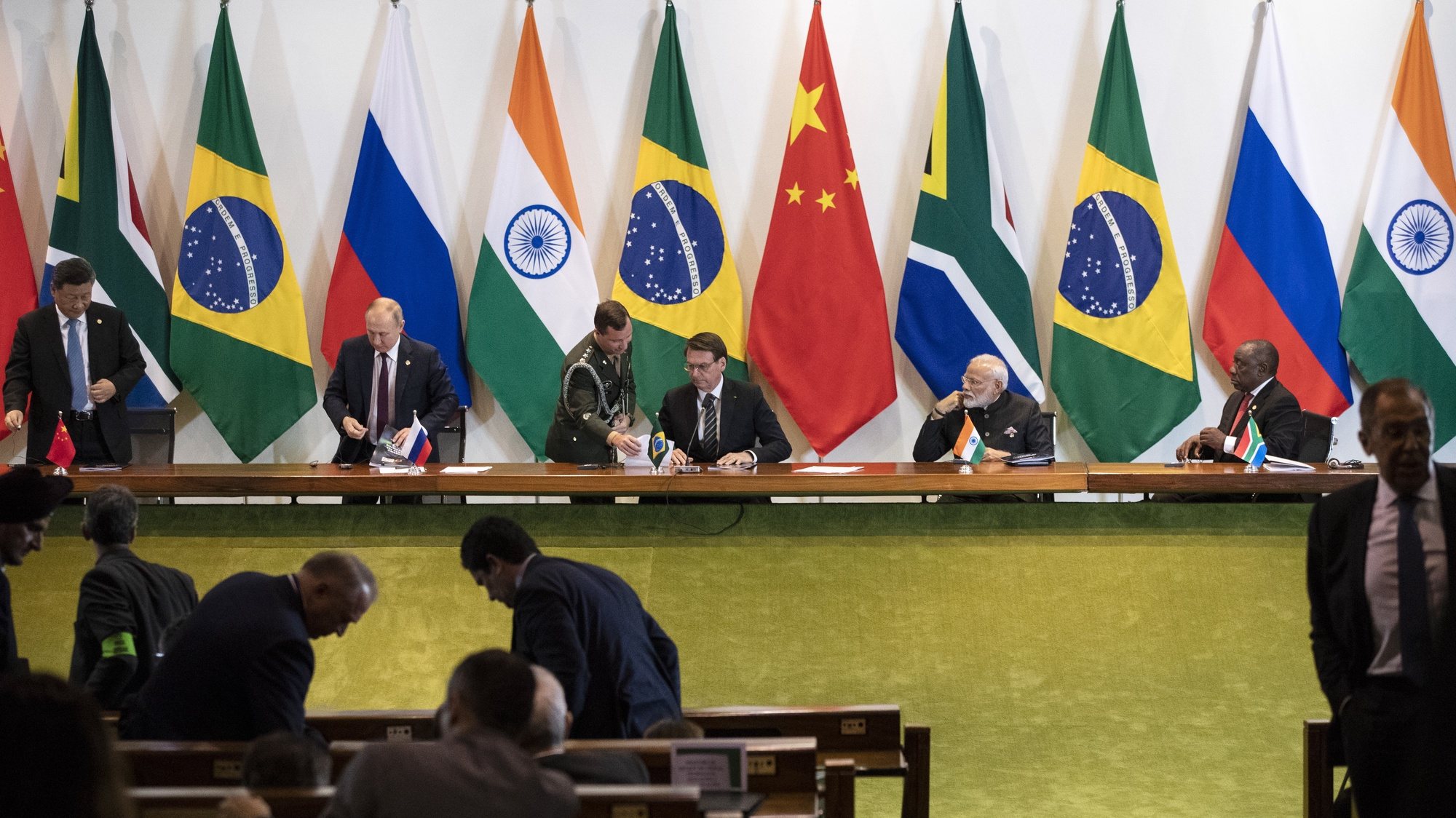 epa07996241 Chinese President Xi Jinping (back  L), Russian President Vladimir Putin (back  2-L), Brazilian President Jair Bolsonaro (back  3-R), Indian Prime Minister Narendra Modi (back 2-R), and South African President Cyril Ramaphosa (back R) at the end of a meeting with members of the Business Council and management of the New Development Bank during  during the 11th BRICS leaders summit at the Itamaraty Palace in Brasilia, Brazil, 14  November 2019.  The BRICS (Brazil, Russia, India, China and South Africa)  leaders summit takes place on 13 -14 November in Brazil.  EPA/PAVEL GOLOVKIN / POOL