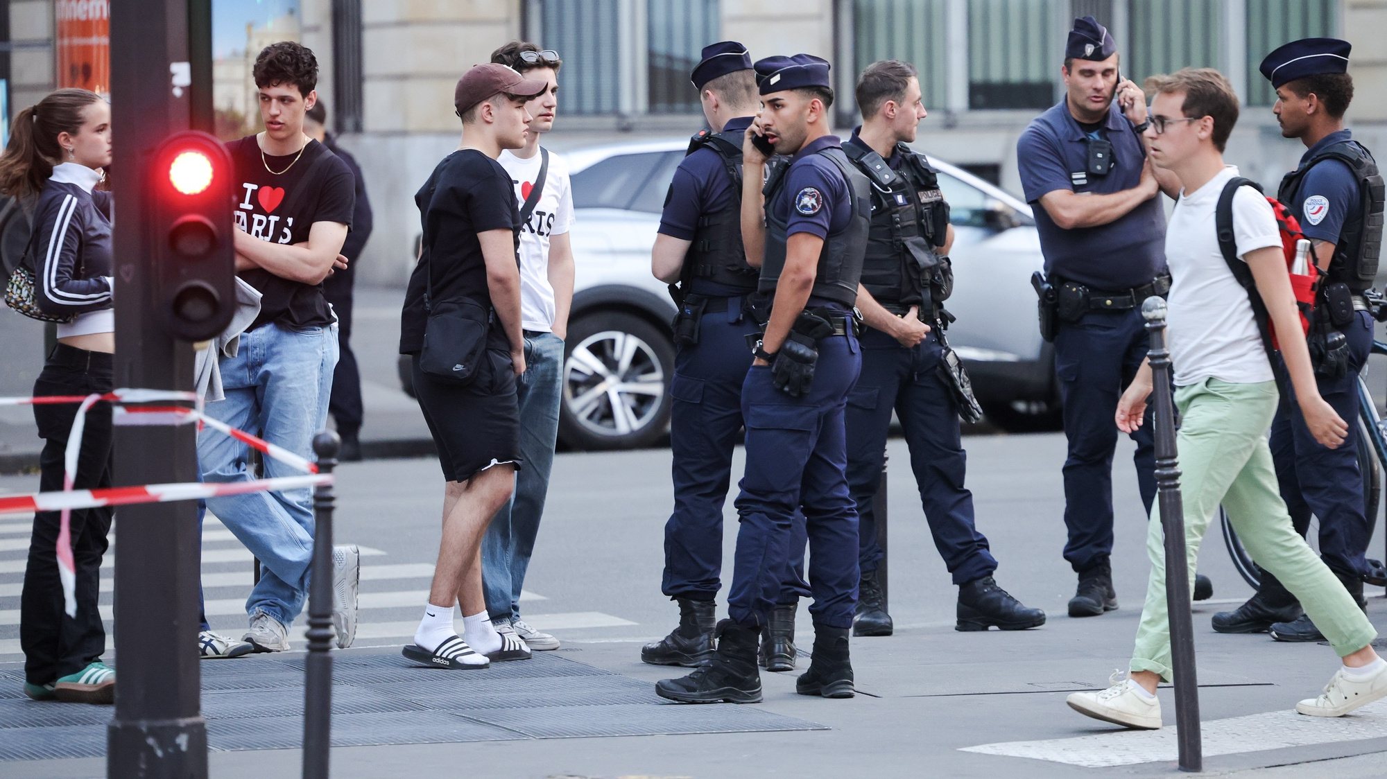 epa10724937 People walk past police officers near the venue of the &#039;One Year to Go Paris 2024&#039; (Dans un An Les Jeux Paris 2024) concert, held amid massive police presence following days of violent protests, in Paris, France, 03 July 2023. Violence broke out across France over the fatal shooting of a 17-year-old teenager by a police officer during a traffic stop in Nanterre on 27 June.  EPA/OLIVIER MATTHYS