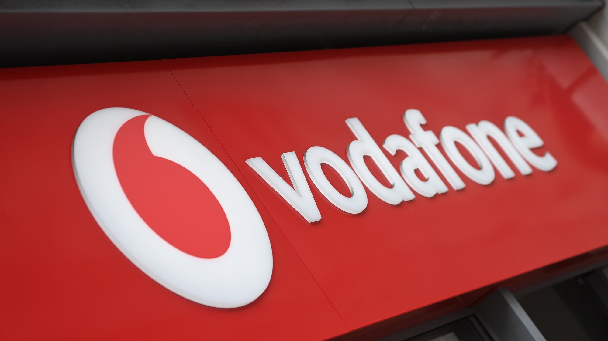 epa10690618 A view of a Vodaphone sign outside a store in London, Britain, 14 June 2023. Vodafone and Three owners CK Hutchison are to merge their UK operations in a deal that will create Britain&#039;s biggest mobile phone company worth £15 billion ($19 billion, €17,5 billion), the companies announced 14 June 2023. The merged firm will be majority owned by FTSE 100-listed Vodafone, with 51% of the combined business and CK Hutchison owning the remaining 49%.  EPA/NEIL HALL
