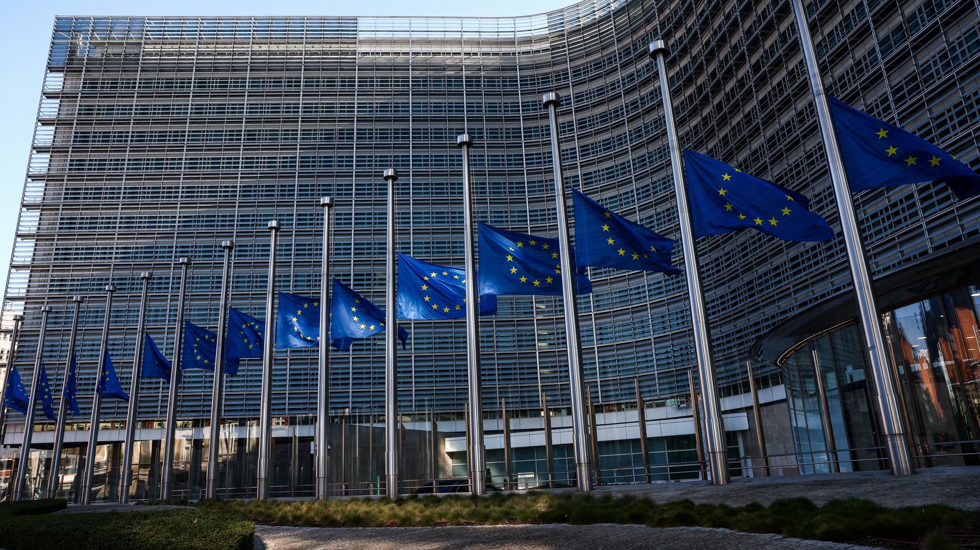 epa10496790 European flags at half mast after train collision in Greece at the European Commission headquarters in Brussels, Belgium, 01 March 2023. A head-on collision between a passenger train and a freight train near Larissa in Greece has left at least 36 people dead.  EPA/STEPHANIE LECOCQ