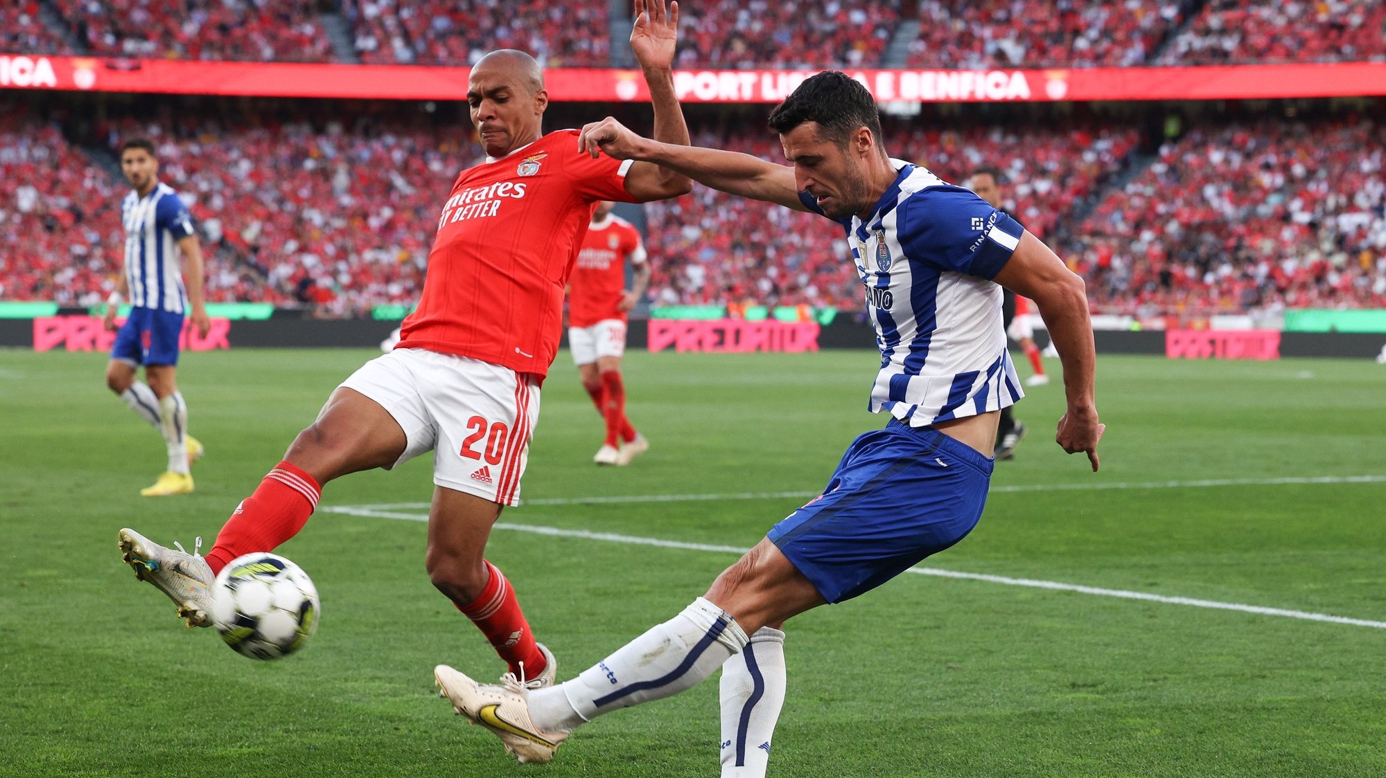 epa10563978 SL Benfica player Joao Mario (L) in action against FC Porto player Marko Grujic (R), during the Portuguese First League soccer match, between SL Benfica and FC Porto, at Luz stadium in Lisbon, Portugal, 07 April 2023.  EPA/TIAGO PETINGA