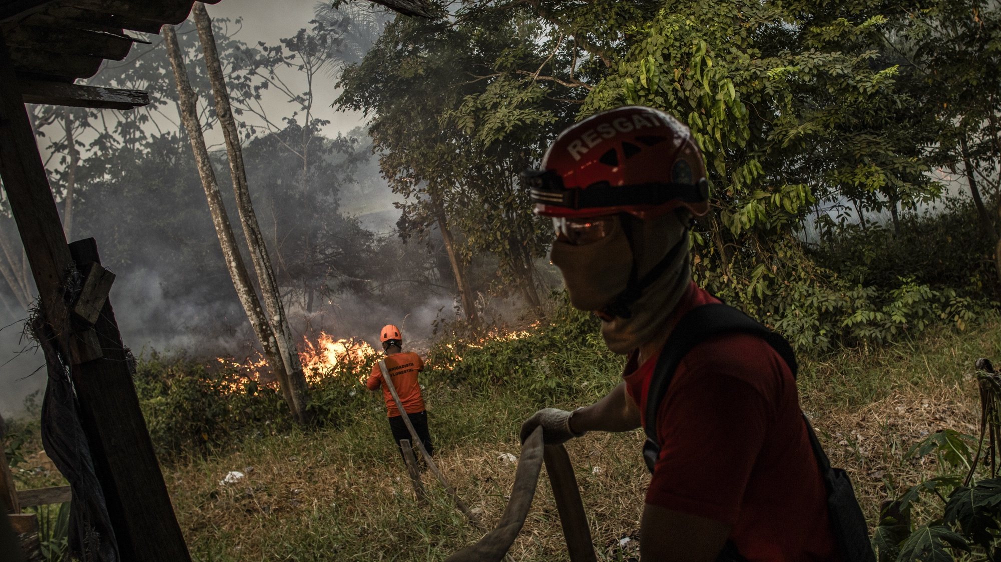 epa10842926 Firefighters working on a fire in a green area between Manaus and Iranduba, in the Amazon, Brazil, on 05 September 2023. The deforested area of the Brazilian Amazon fell 66% in August compared to the same month last year and reached the lowest figure since 2018, according to official data released on 05 September.  EPA/Raphael Alves