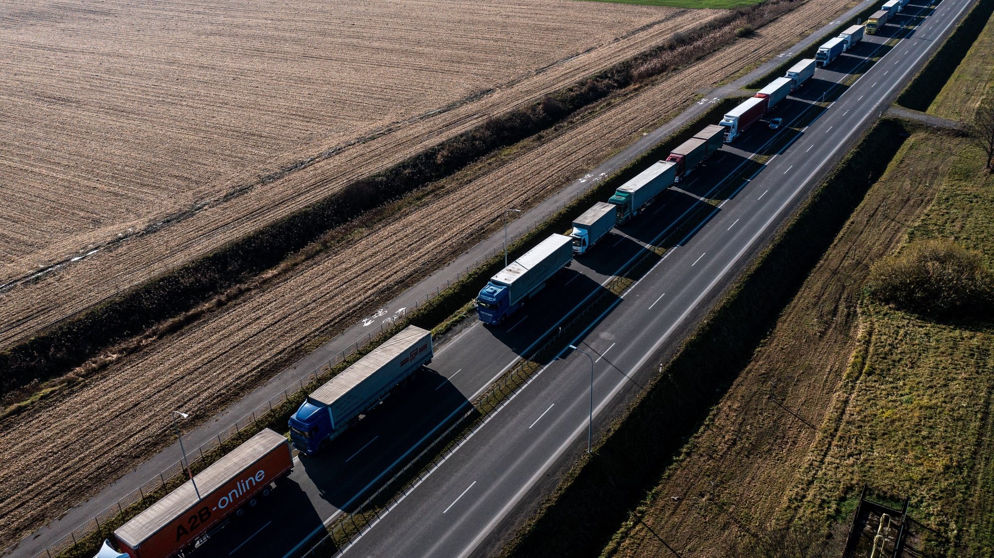 epa10978452 An aerial photo made with a drone shows trucks standing in a queue at the Polish-Ukrainian border in Medyka, southeastern Poland, 16 November 2023. Trucks waiting to get into Ukraine at the Medyka border crossing in south-eastern Poland have to wait in long queues due to a blockade by Polish lorry drivers at the Dorohusk and Hrebenne border crossings, south-eastern Poland, in protest over what they see as unfair competition from Ukrainian road haulage companies.  EPA/DAREK DELMANOWICZ POLAND OUT