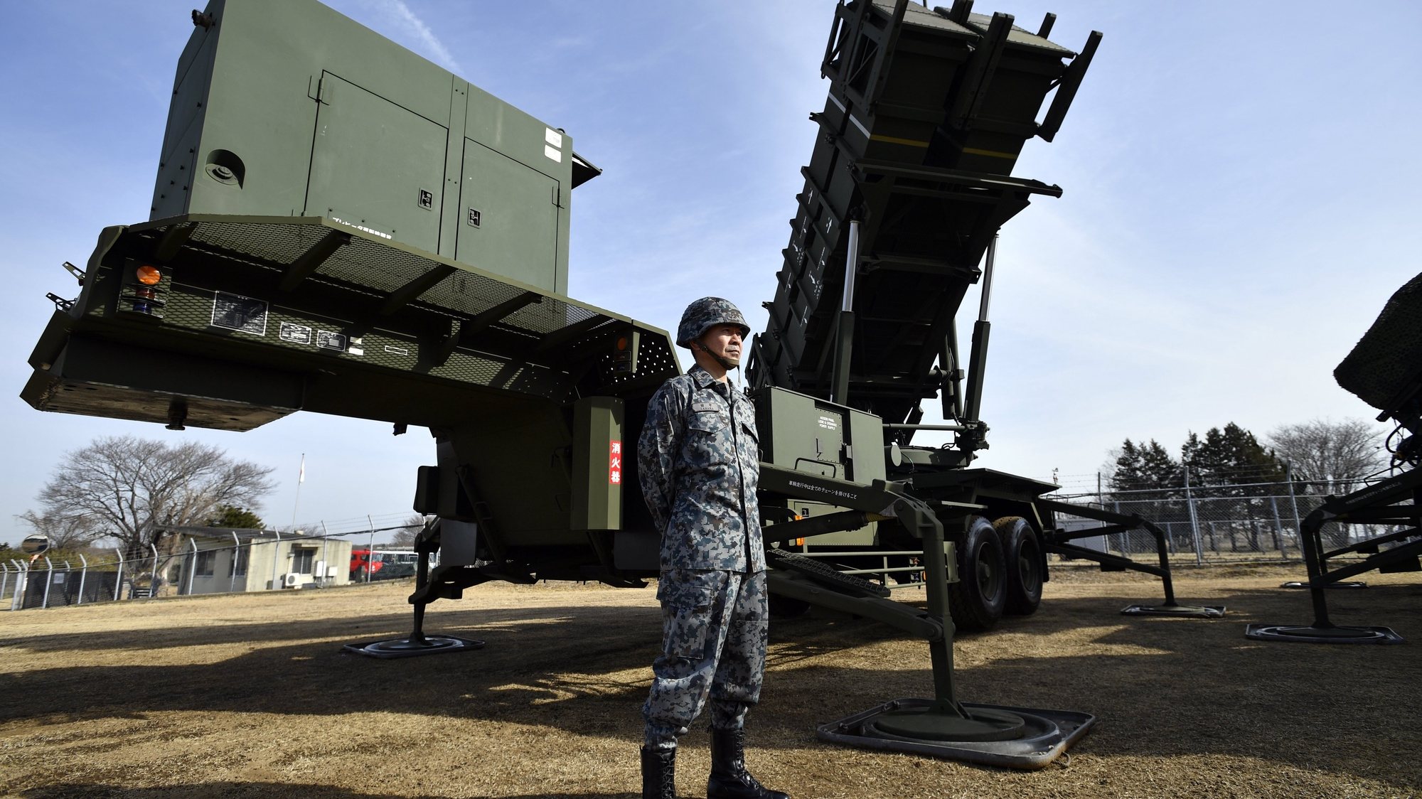 epaselect epa06448455 A Japan Ground Self-Defense Force (JGSDF) soldier stands at guard before a Patriot Advanced Capability-3 (PAC-3) ballistic missiles interceptor deployed at Camp Narashino in Funabashi, Chiba Prefecture, Japan, 18 January 2018.  EPA/FRANCK ROBICHON
