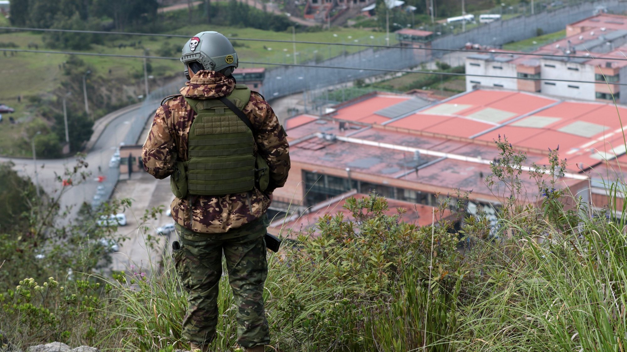 epa11076801 A soldier watches over the surroundings of the Turi prison during the military and police operation to regain control of the penitentiary center, in Cuenca, Ecuador, 14 January 2024. Ecuadorian President Daniel Noboa announced on X (formerly Twitter) that joint operation of Armed Forces and the Police released the prison security and surveillance force and the administrative personnel who were held in Detention Centers, after a violent week of attacks by organized crime. Following the attacks and violent acts that occurred on 09 January in the country, Noboa decreed a state of emergency, declared the existence of an internal armed conflict, and ordered the Public Force to carry out security and control operations in different locations in Ecuador.  EPA/Xavier Calvinagua