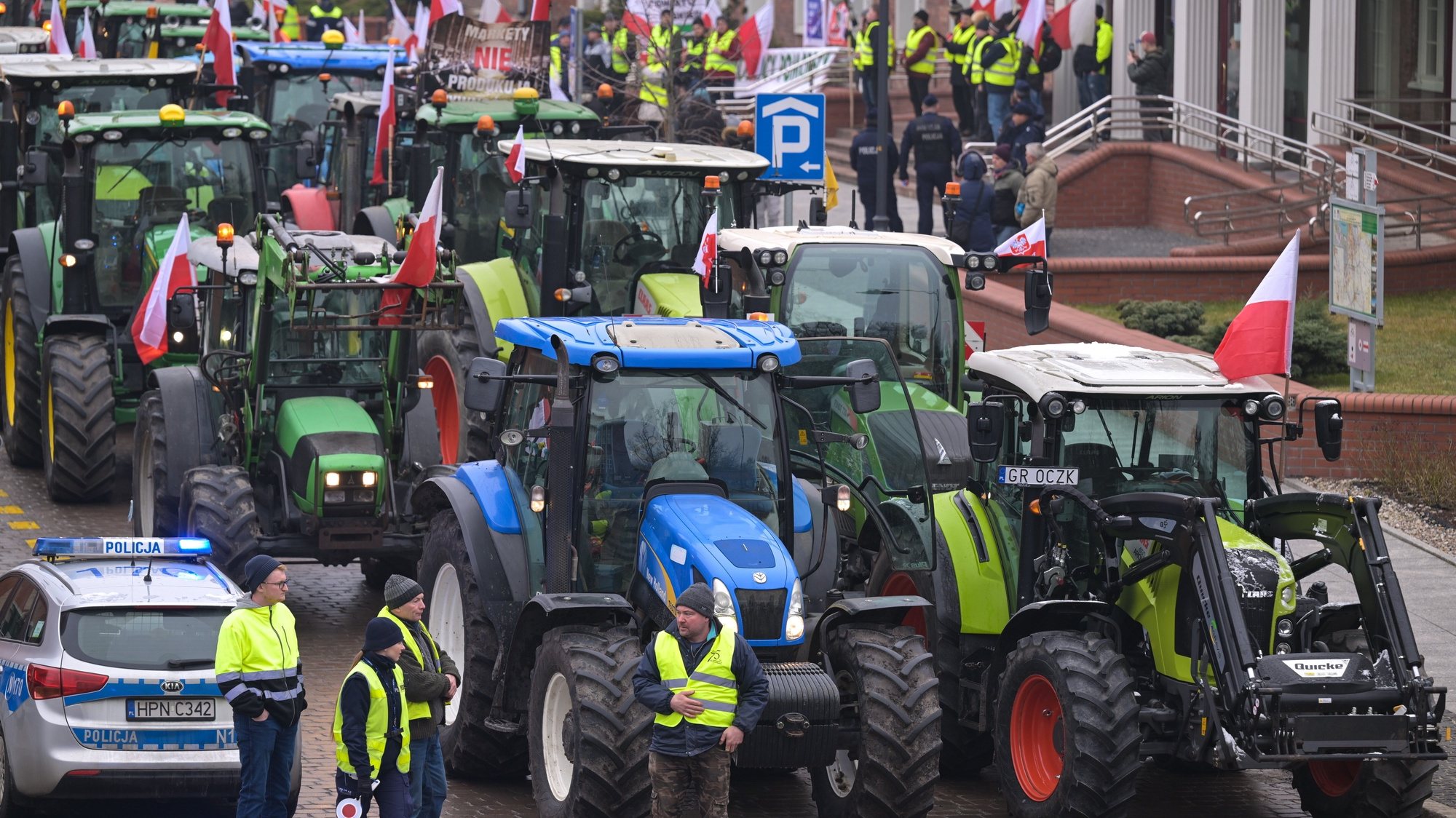 epa11139022 Polish farmers block traffic during a protest in Gdansk, Poland, 09 February 2024. Polish farmers announced a nationwide protest on 09 February against the European Green Deal and the influx of goods coming from Ukraine, expected to last for 30 days. The protest was sparked by the recent decision by the European Commission to extend the duty-free trade with Ukraine until 2025. Farm vehicles, such as tractors, as well as pedestrians blocked roads in different parts of the country.  EPA/Adam Warzawa POLAND OUT
