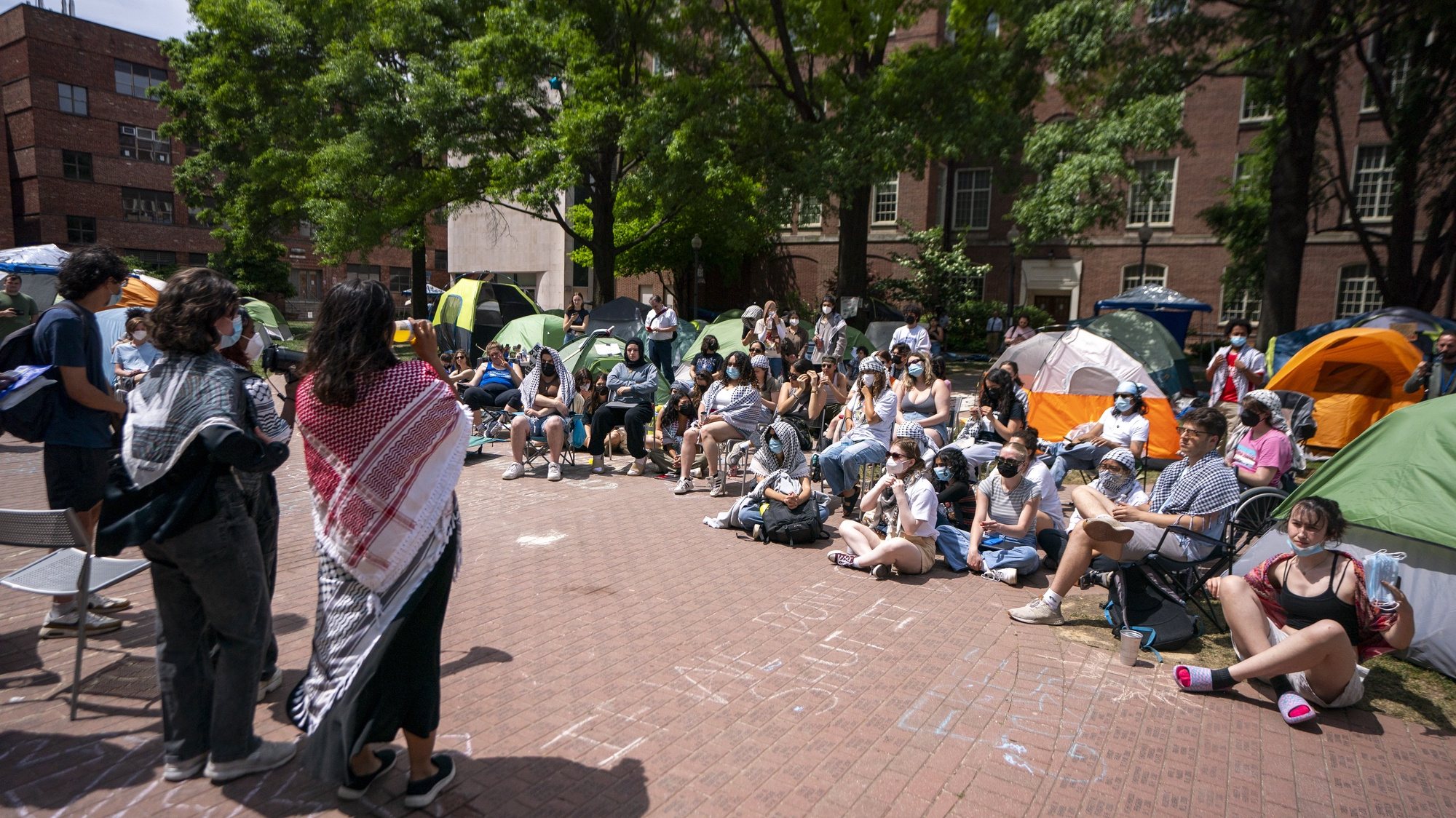 epa11316746 Activists participate in a community meeting at the ongoing encampment of pro-Palestinian protesters in the University Yard at George Washington University (GWU) in Washington, DC, USA, 03 May 2024. Nationwide protests have sprung up across the country on school campuses, many calling for institutions to divest investments in Israel and in support of a ceasefire in the Gaza conflict.  EPA/SHAWN THEW