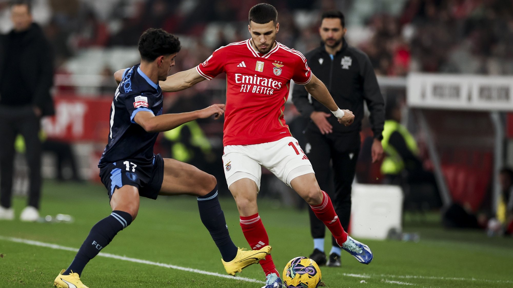epa11048713 Benfica player David Jurasek (R) in action against Famalicao player Afonso Rodrigues during the Portugal First League Soccer round 15 match Benfica vs Famalicao held at Luz Stadium, Lisbon, Portugal, 29 December 2023.  EPA/JOSE SENA GOULAO
