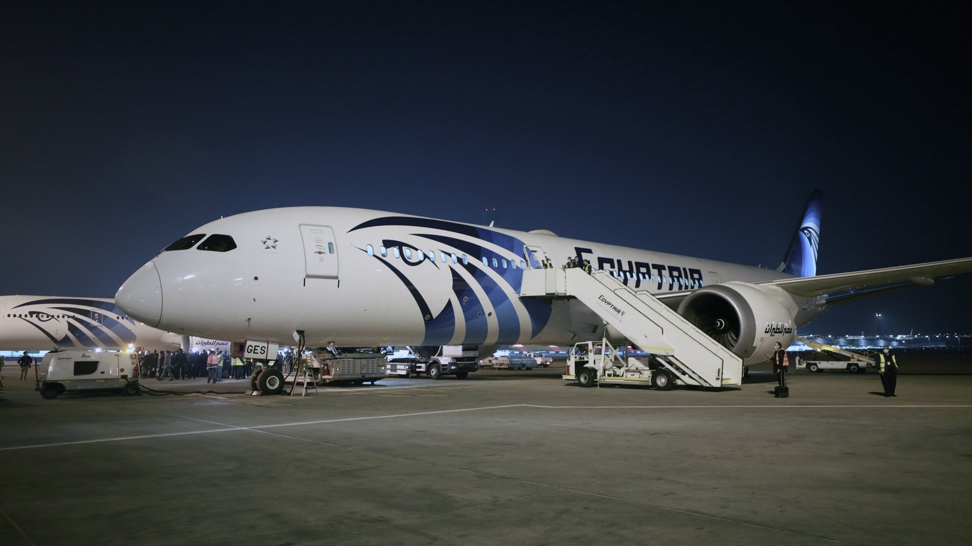 epa09030543 A plane from Egypt&#039;s state-owned carrier, EgyptAir, sits on a runway after transfering the second batch of the Sinopharm vaccine from China, after arrival at Cairo International Airport, in Cairo, Egypt, 23 February 2021.  EPA/KHALED ELFIQI