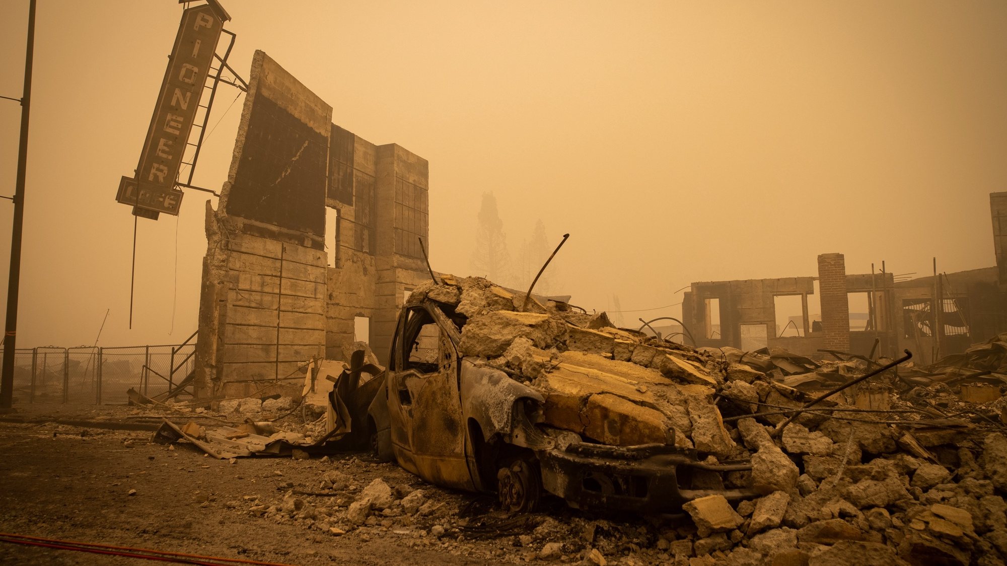 epa09404930 Buildings and vehicles are left destroyed by the Dixie Fire in Greenville, California, USA, 07 August 2021. The Dixie Fire had grown to over 440,000 acres as of 07 August.  EPA/CHRISTIAN MONTERROSA
